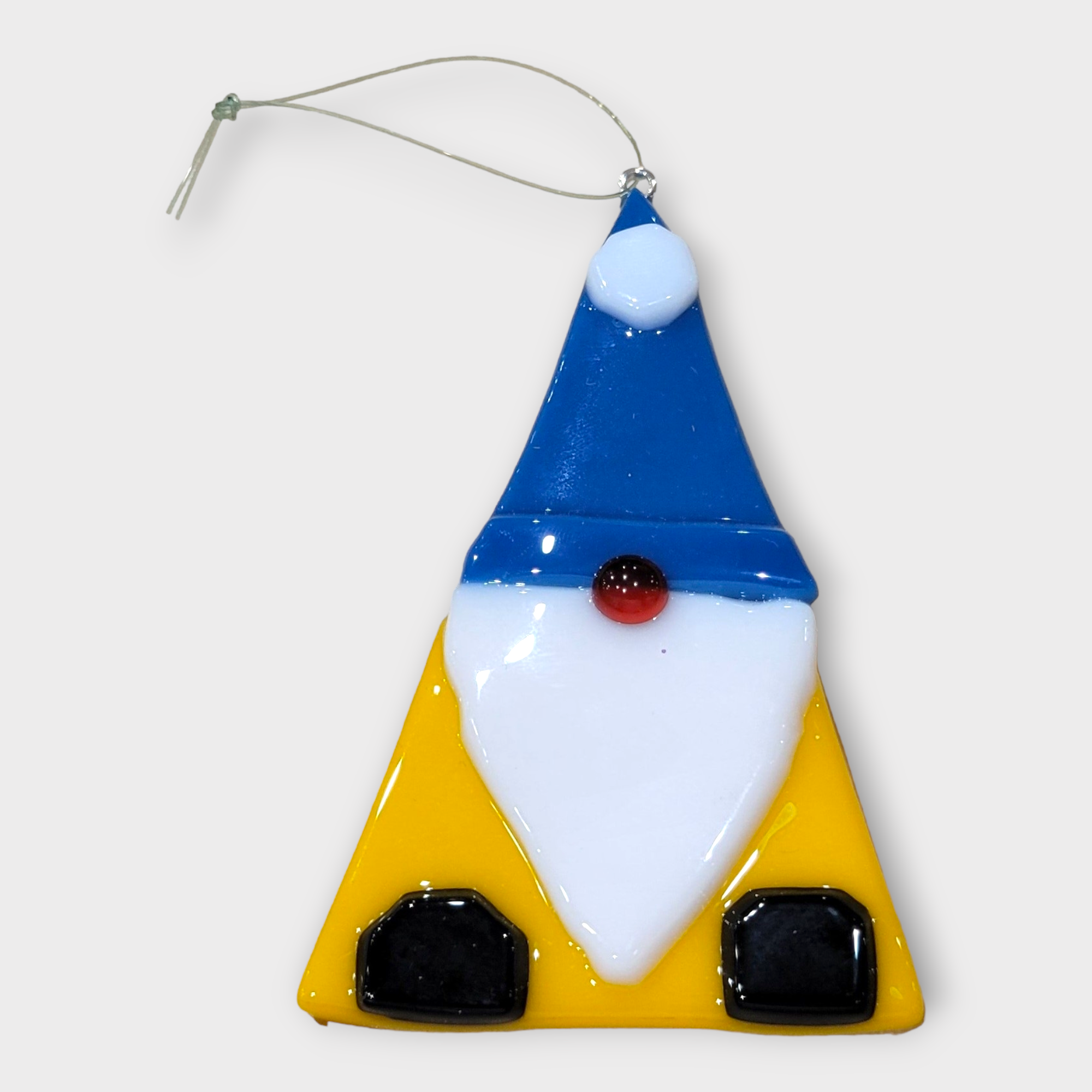 Add Nordic charm to your Christmas tree with this 3"x2" Glass Gnome Ornament, featuring a blue hat, white beard, red nose, and yellow body—perfect for whimsical Scandinavian holiday décor.