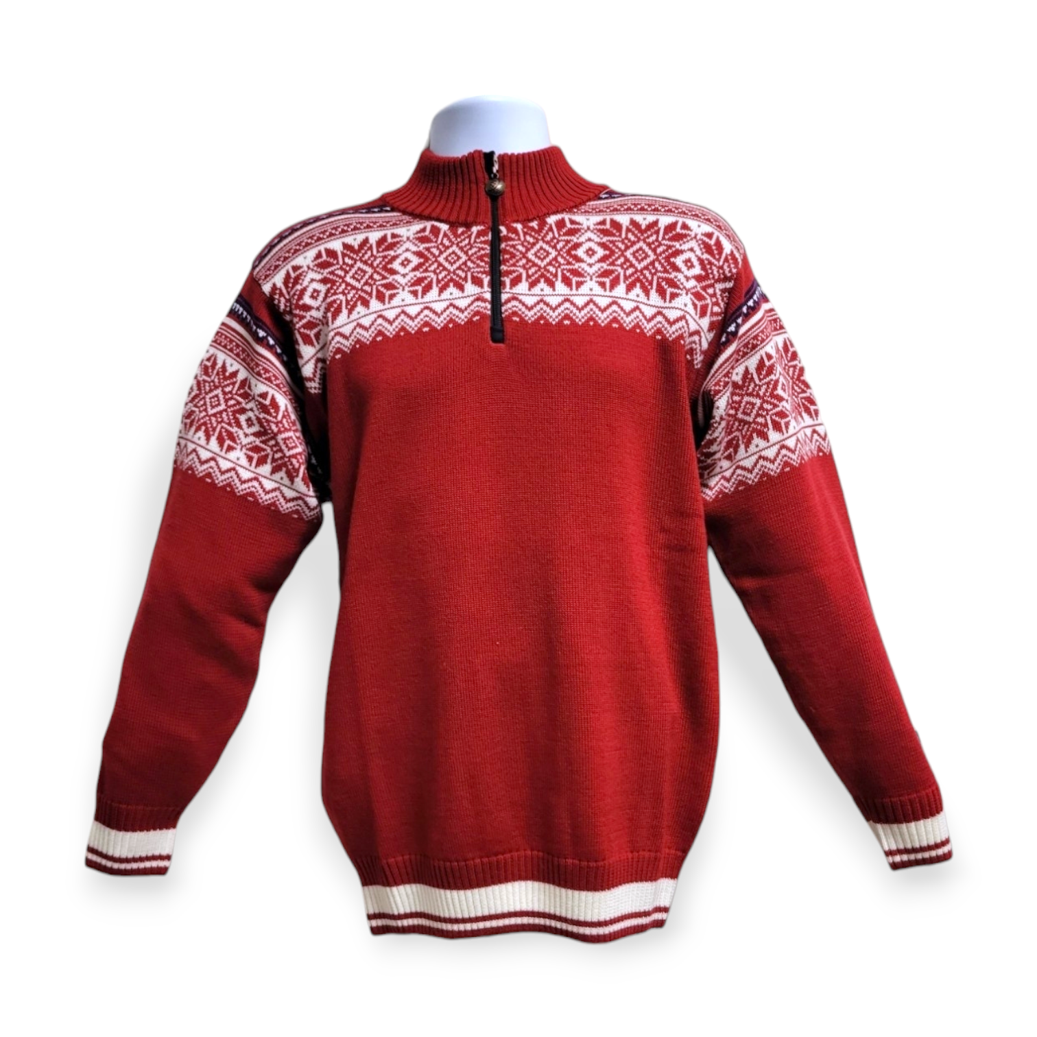 This luxurious piece, the Arctic Circle sweater from Tor, showcases a red design adorned with white geometric patterns and a stylish half-zip collar, all crafted from the finest merino wool.