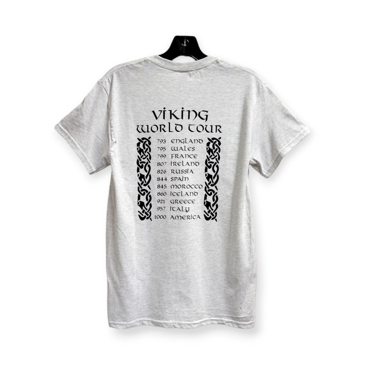 Introducing the "Viking World Tour" Tee: This gray T-shirt proudly displays a list of years and countries, including England, Wales, and France, on the back. Crafted from 100% Gildan Heavy Cotton for superior comfort and durability.