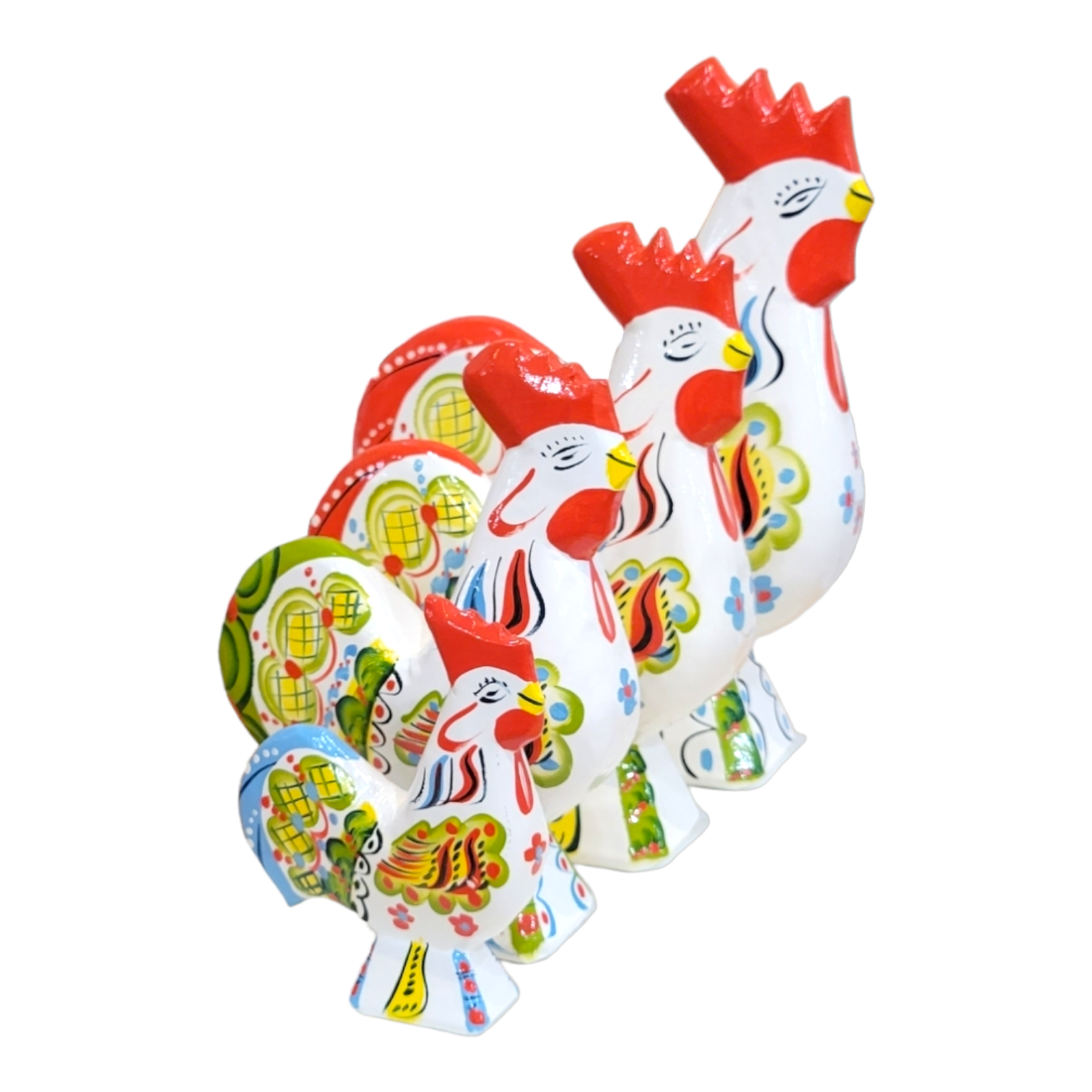 Four vibrant Dala Rooster figurines in white ceramic, adorned with detailed floral patterns, stand proudly in a row, beautifully showcasing the fusion of Swedish craftsmanship with kurbits style.