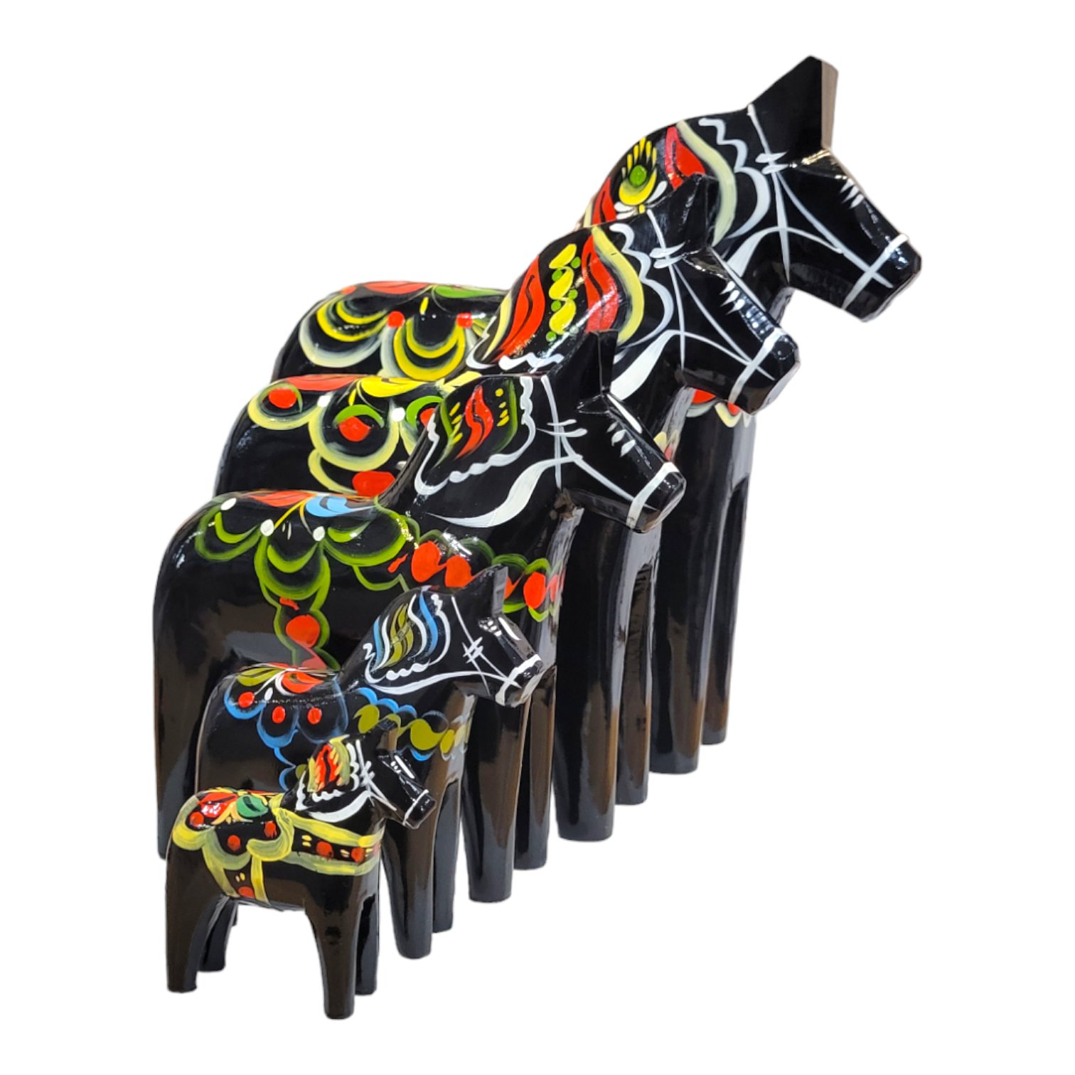 The "Dala Horse: Black" set consists of seven hand-carved wooden horse figurines, featuring vibrant patterns and arranged in descending order of size, reminiscent of traditional Swedish craftsmanship.