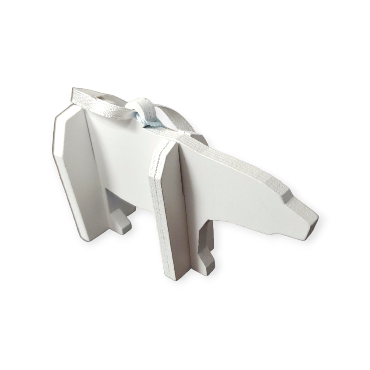 White cardboard cutout tree ornament featuring Tiny the Polar Bear from the Polar Bear Wish Book, with silver edges and a ribbon on top.