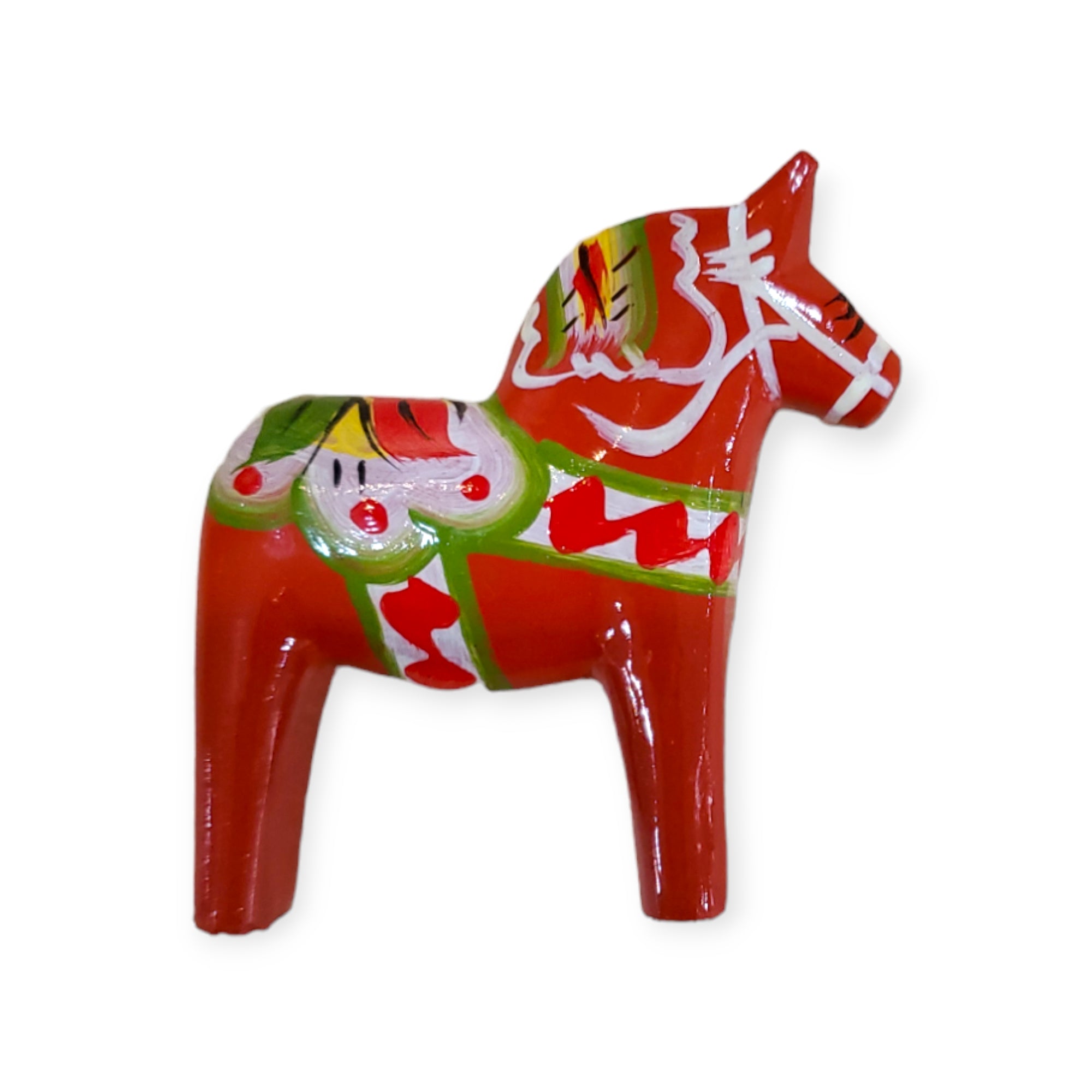 A 2" traditional Dala Horse magnet, handcrafted in Sweden, features red wood with green, white, and yellow Folk Art patterns—an authentic Swedish keepsake.