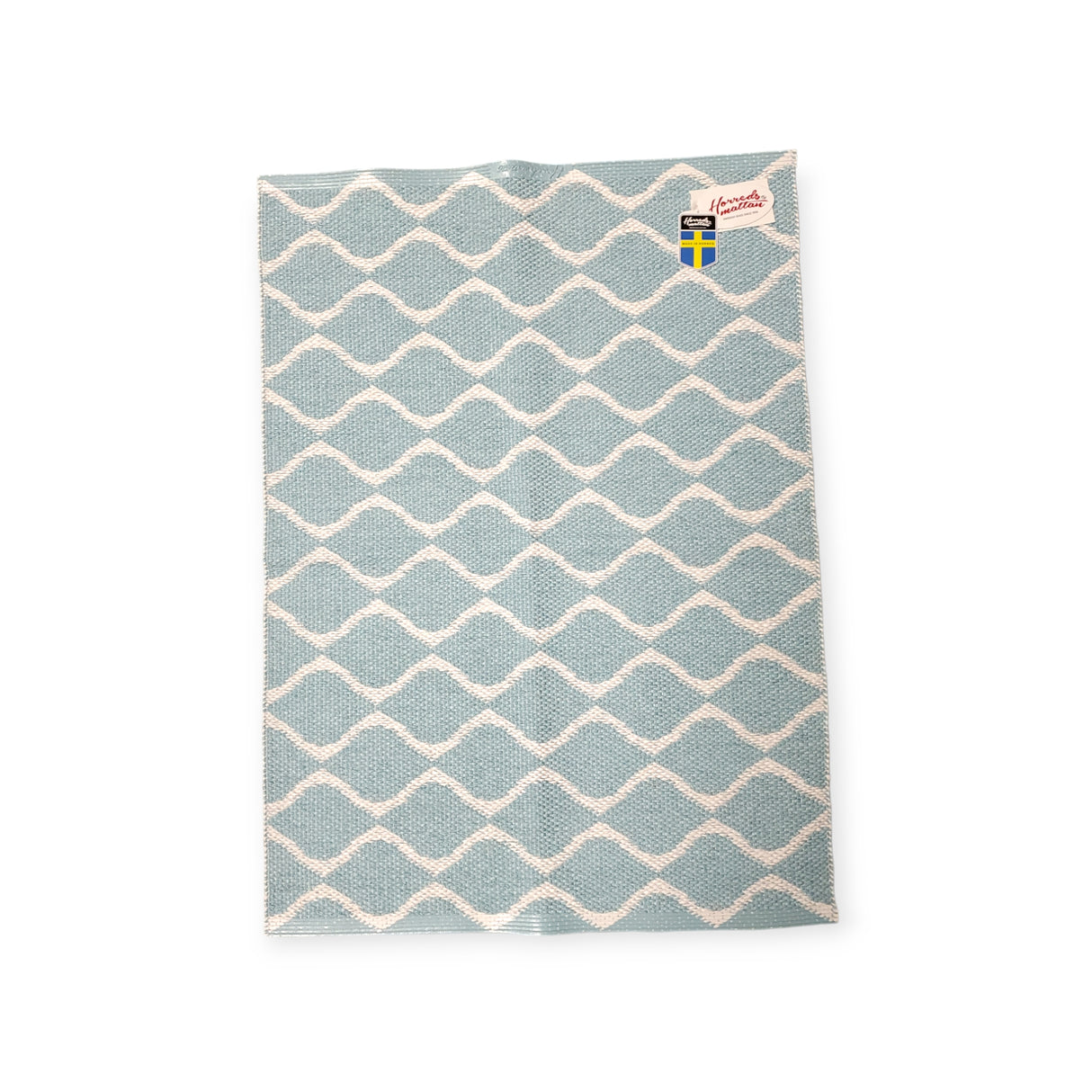 Swedish dishcloth featuring a blue and white wavy pattern, inspired by the long-lasting durability of the Rug: Wave Blue.