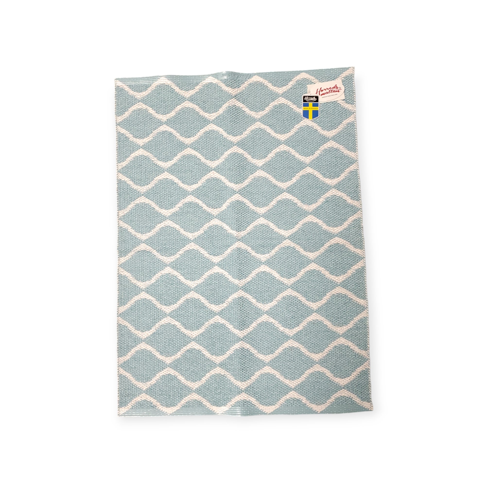 Swedish dishcloth featuring a blue and white wavy pattern, inspired by the long-lasting durability of the Rug: Wave Blue.