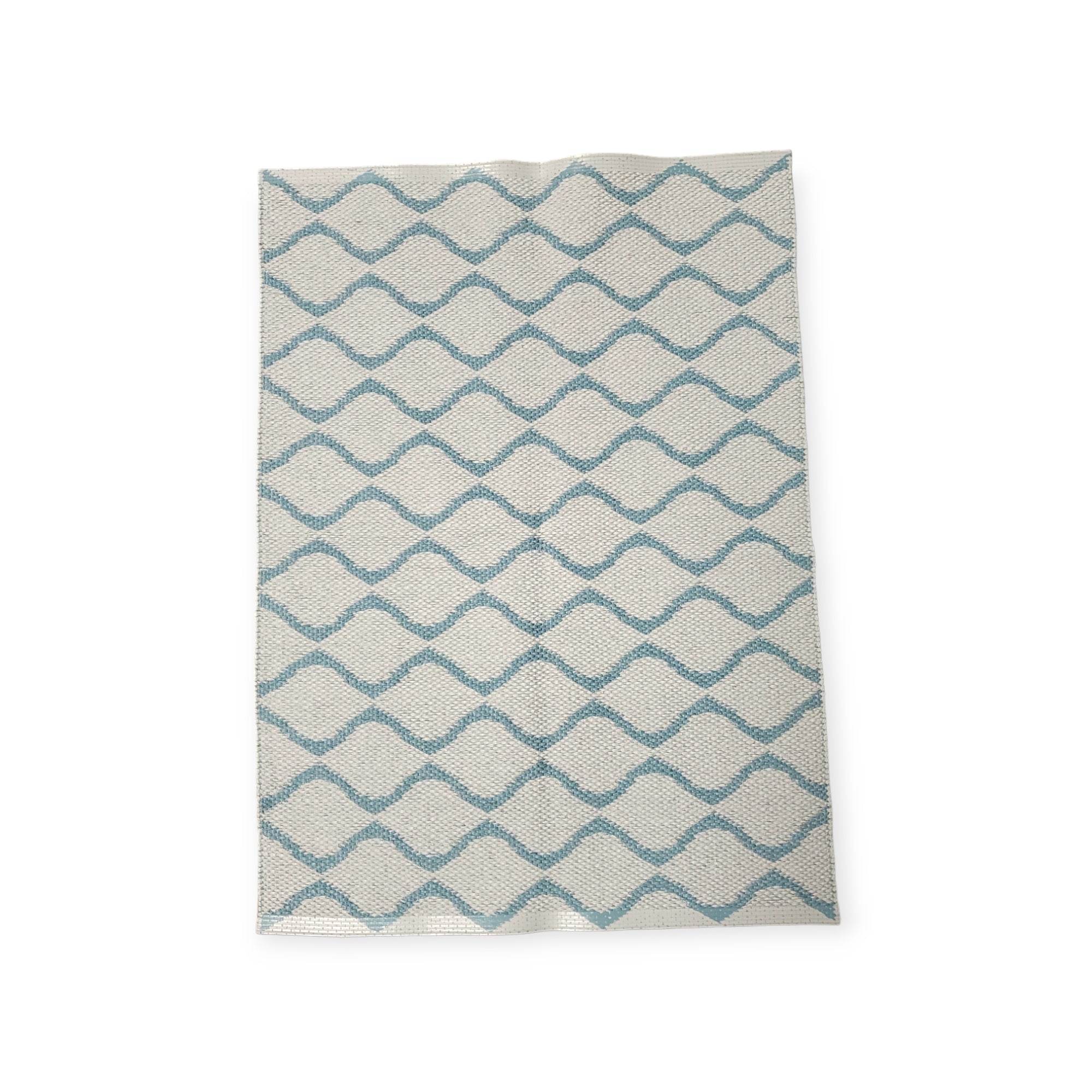 The Rug: Wave Blue features a geometric zigzag pattern in blue and white, crafted from durable Swedish vinyl, ensuring lasting appeal.
