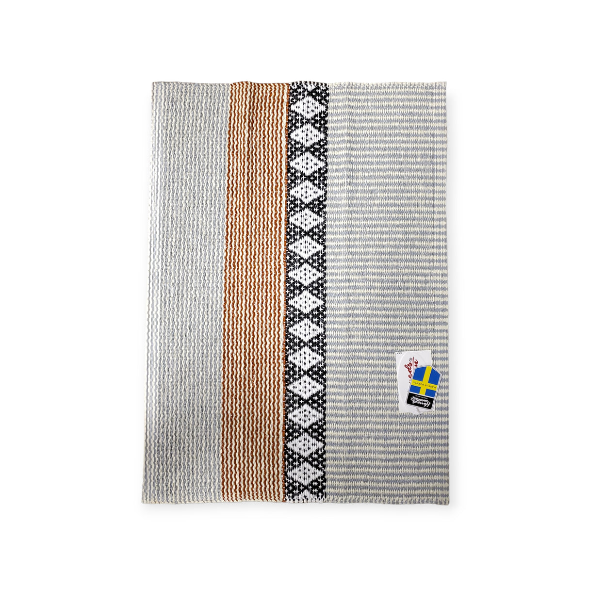 A rug with vertical stripes in gray, tan, and black patterns, featuring a Horredsmattan Swedish-themed tag in the corner, named Rug: Savanne Light Grey Vinyl.