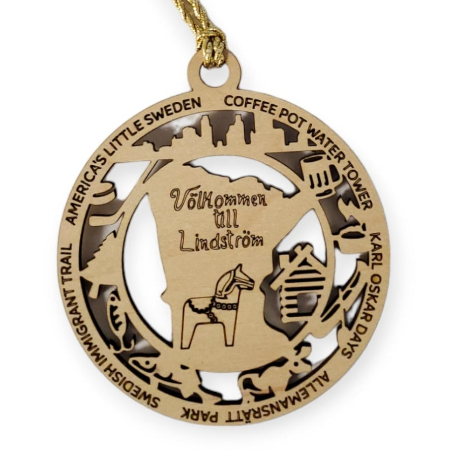 The Ornament: Valkommen to Lindstrom Laser Cut Wood Ornament features Minnesotas outline, a Dala horse, and the words Välkommen till Lindström, with iconic landmarks like the Coffee Pot Water Tower and nods to Karl Oskar Days, celebrating Swedish heritage.