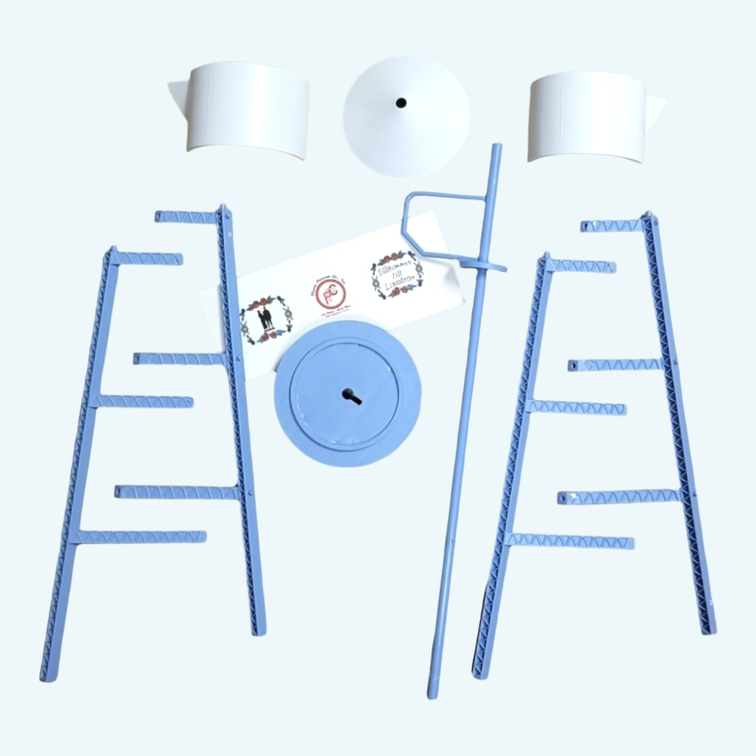 The Model Kit: Miniature Replica of the Lindström Coffee Pot Water Tower features metal scaffolding parts, white plastic cones, a round base, and a handled vertical rod, all displayed neatly on a light background.