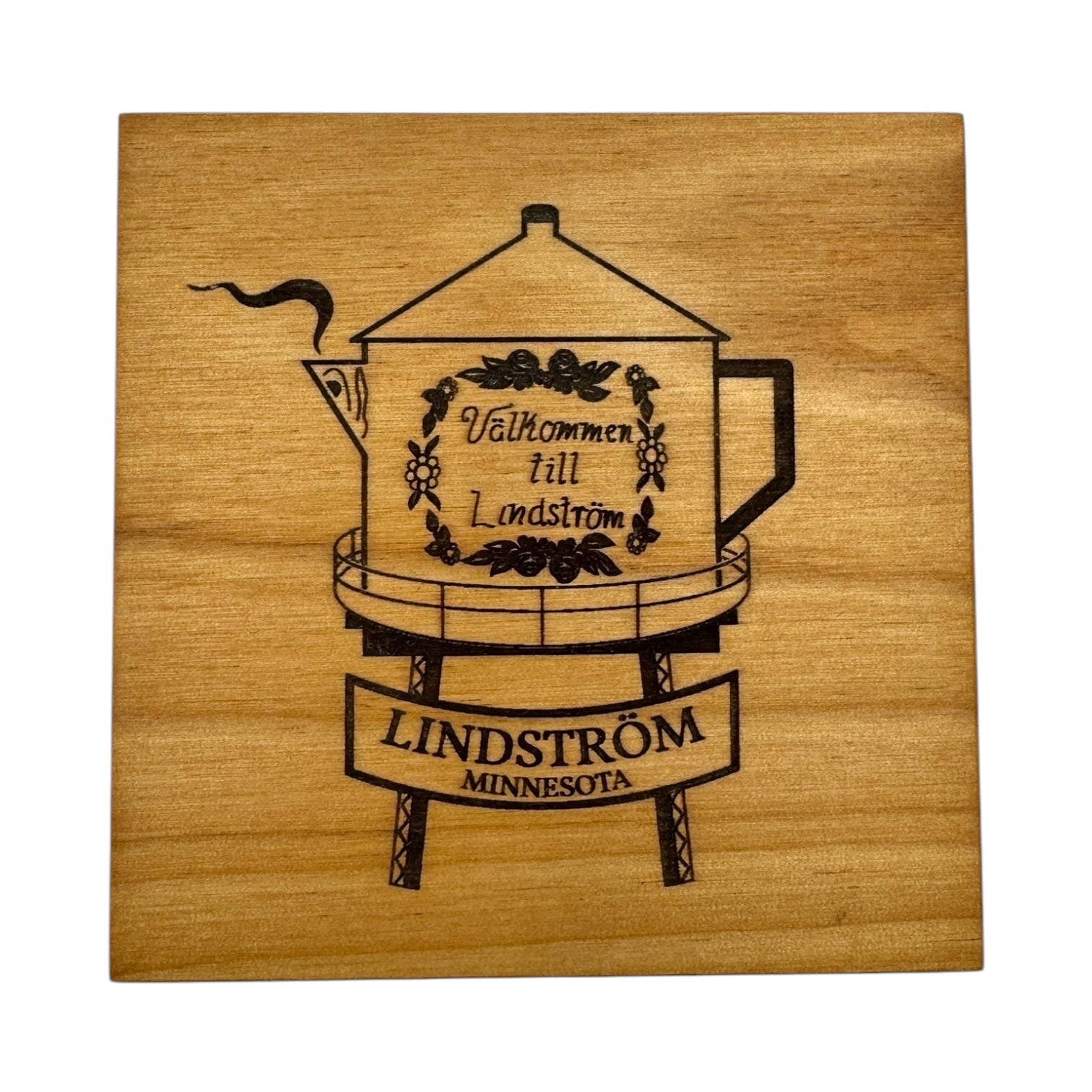 A 4x4 square alder coaster features the Lindstrom Coffee Pot Water Tower with Swedish text and floral design, plus a platform labeled Lindström Minnesota—a charming tribute to Scandinavian FIKA tradition.