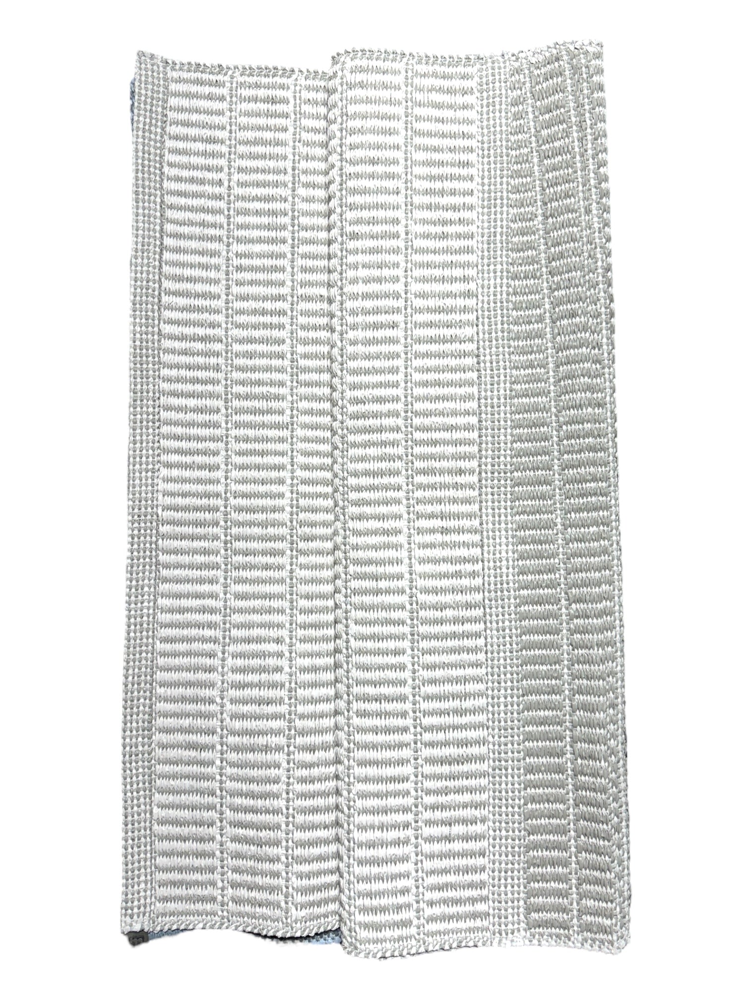 A folded white textured cloth with vertical ribbed patterns, shown on a white background—resembling the eco-friendly Vinyl Rug: Horredsmattan - Mai (28 x 60).