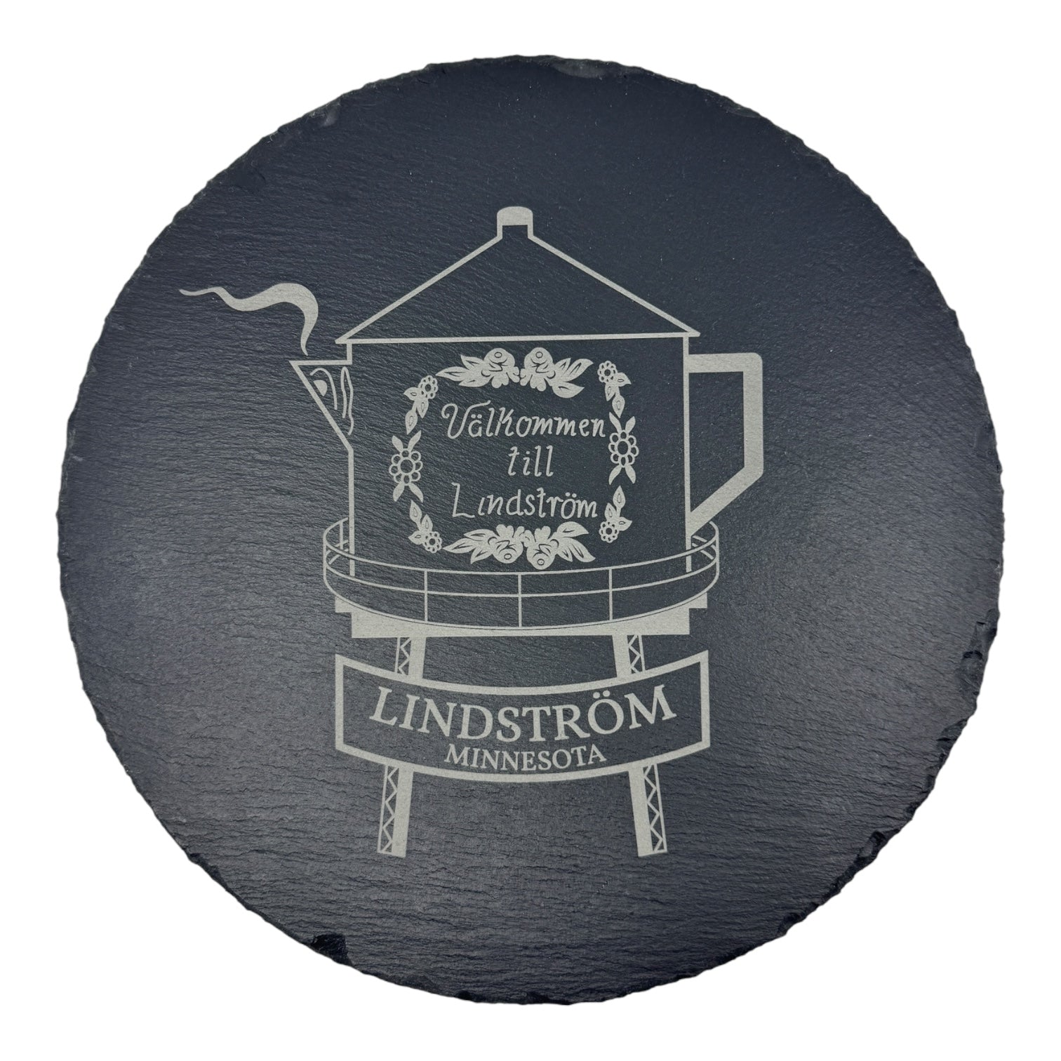 The Trivet: Lindstrom Coffee Pot Water Tower on 9.75 Slate Trivet features an engraved image of the iconic Minnesota landmark with floral accents and the words Välkommen till Lindstrom and Lindström Minnesota.