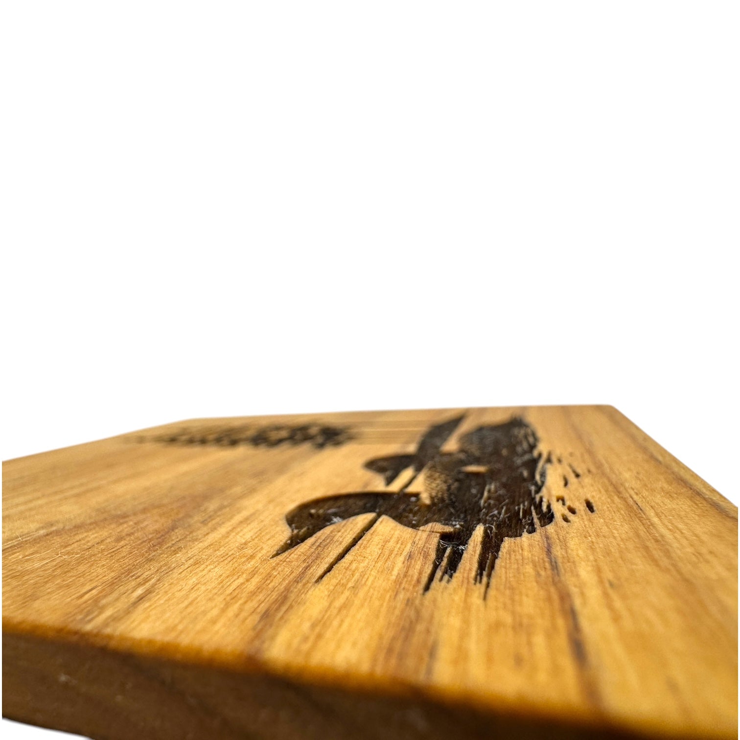 Close-up of the Coaster: Two Loons on the Lake 4x4 Alder Coaster, featuring an engraved pattern, photographed from a low angle against a white background—ideal for adding a nature-inspired touch to your decor.