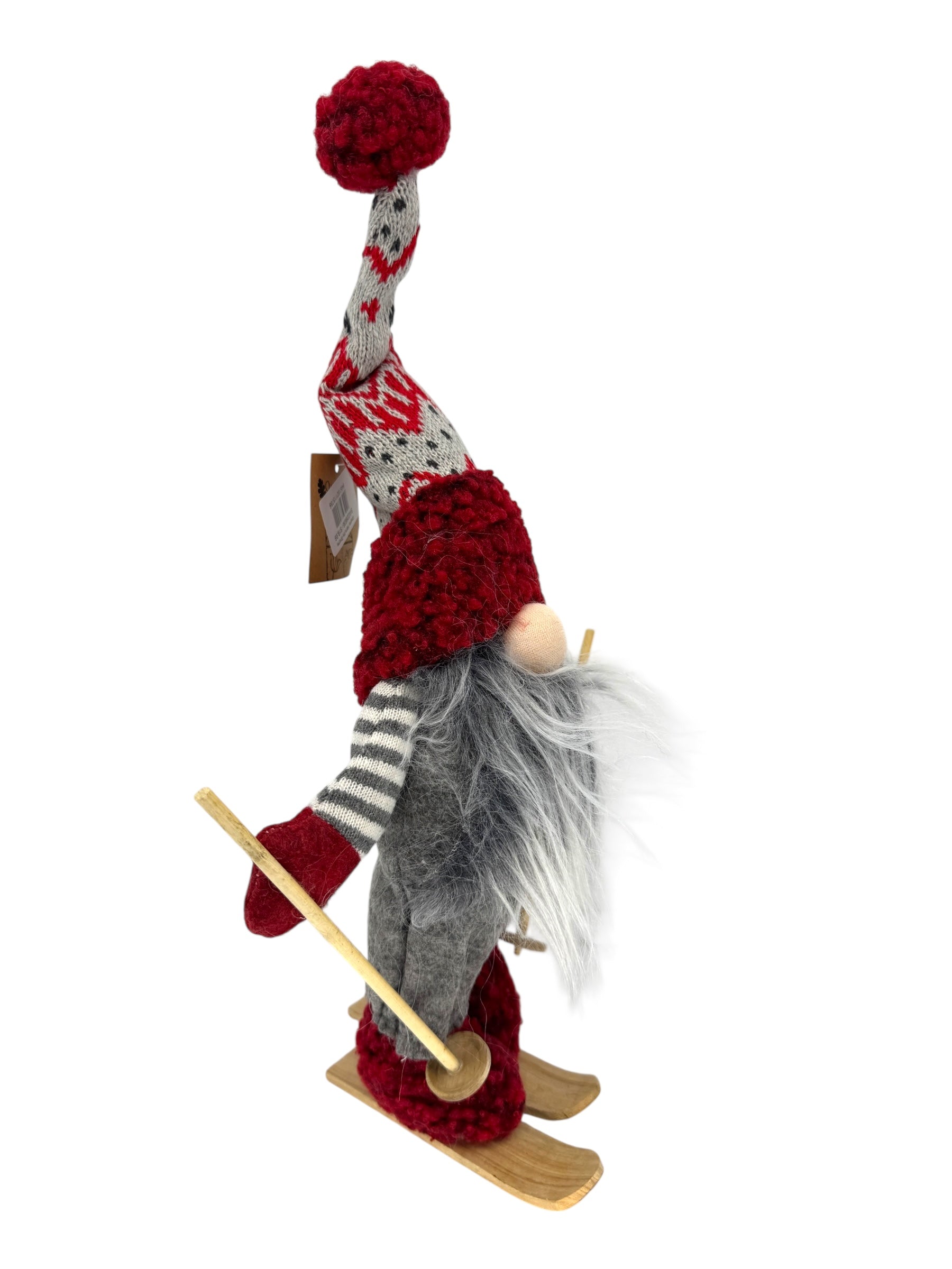 Nene the Gnome is a 15 plush Scandinavian figurine with a red and gray knit hat, gray beard, striped mittens, and red boots on wooden skis—perfect as a skiing holiday or Christmas table decoration.