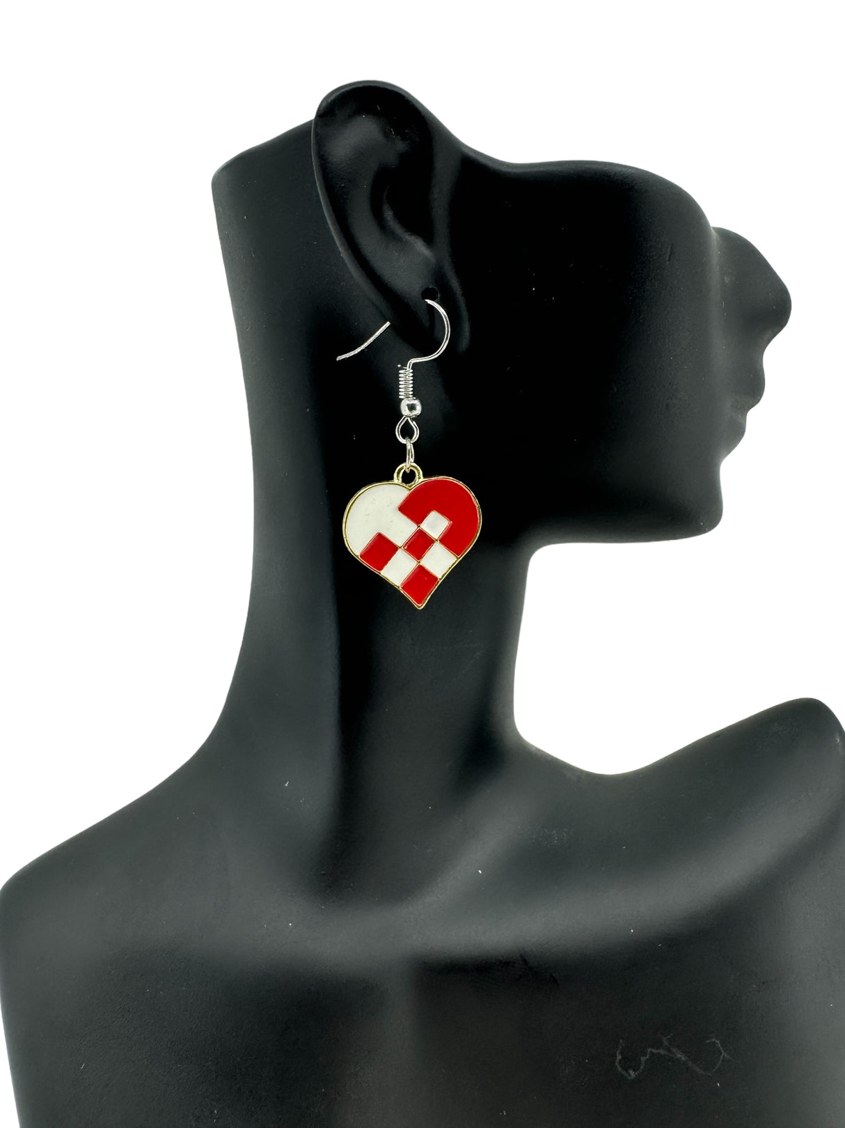 A mannequin head showcases the Danish Braided Heart Earrings, crafted from enameled metal in red and white Danish flag colors, dangling elegantly from hooks.
