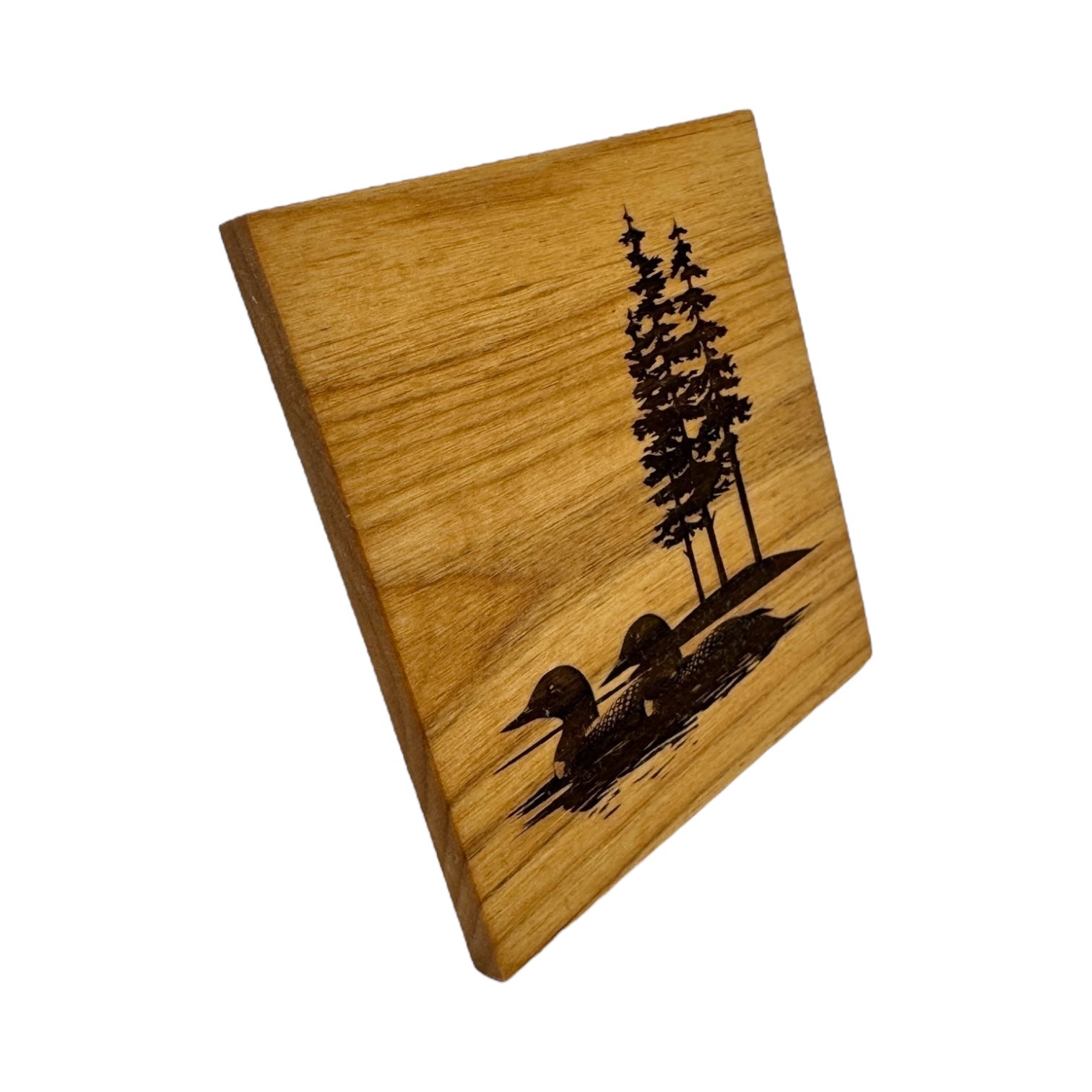 Add a touch of nature to your decor with the Coaster: Two Loons on the Lake 4x4 Alder Coaster, featuring an engraved design of two loons on water and three tall trees in the background.