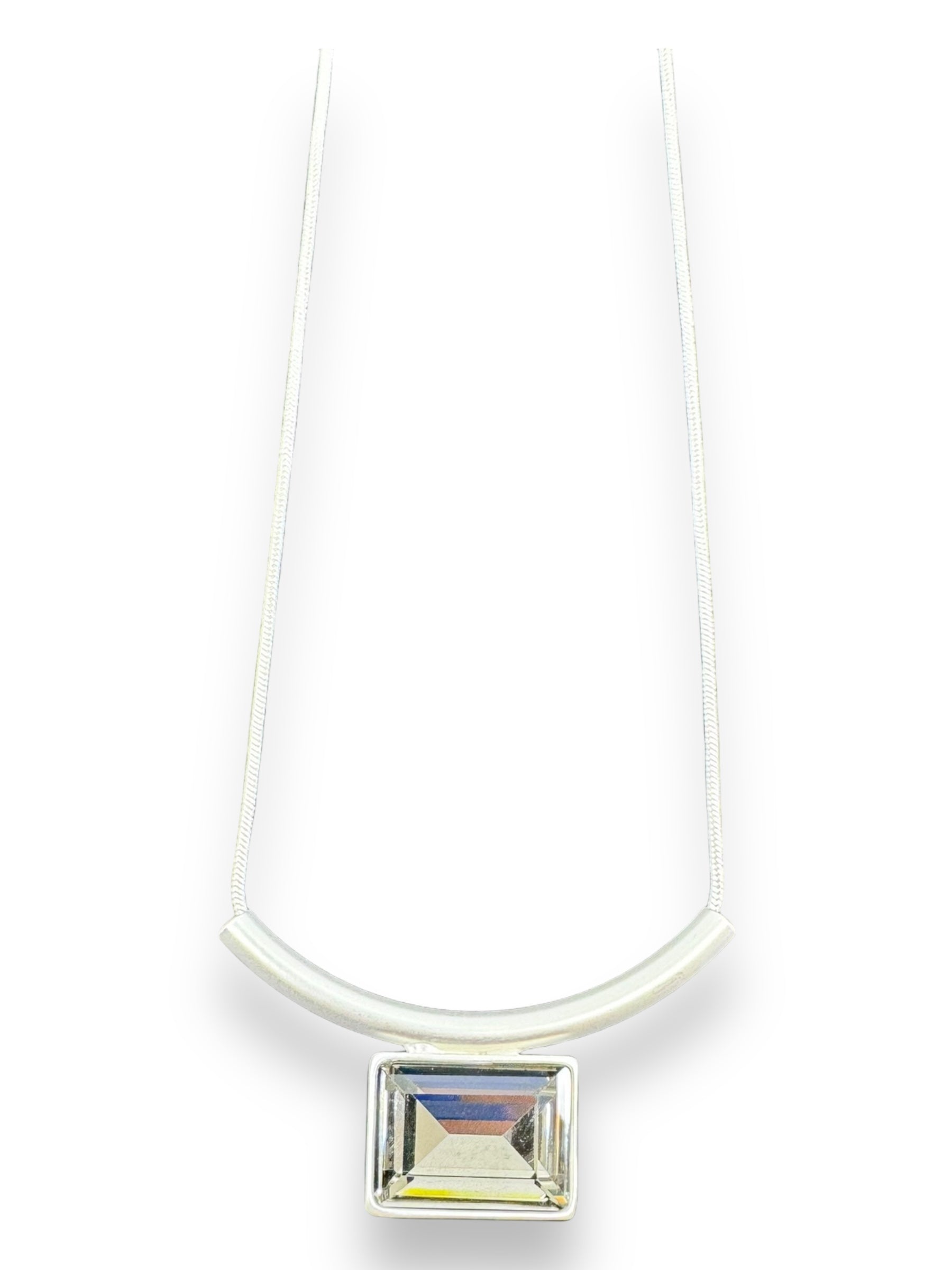 The Audrey Black Diamond Silver Plated Necklace by DANSK Copenhagen features a minimalistic design with a silver chain, rectangular clear gemstone pendant, and curved metallic bar, capturing the essence of Nordic design.