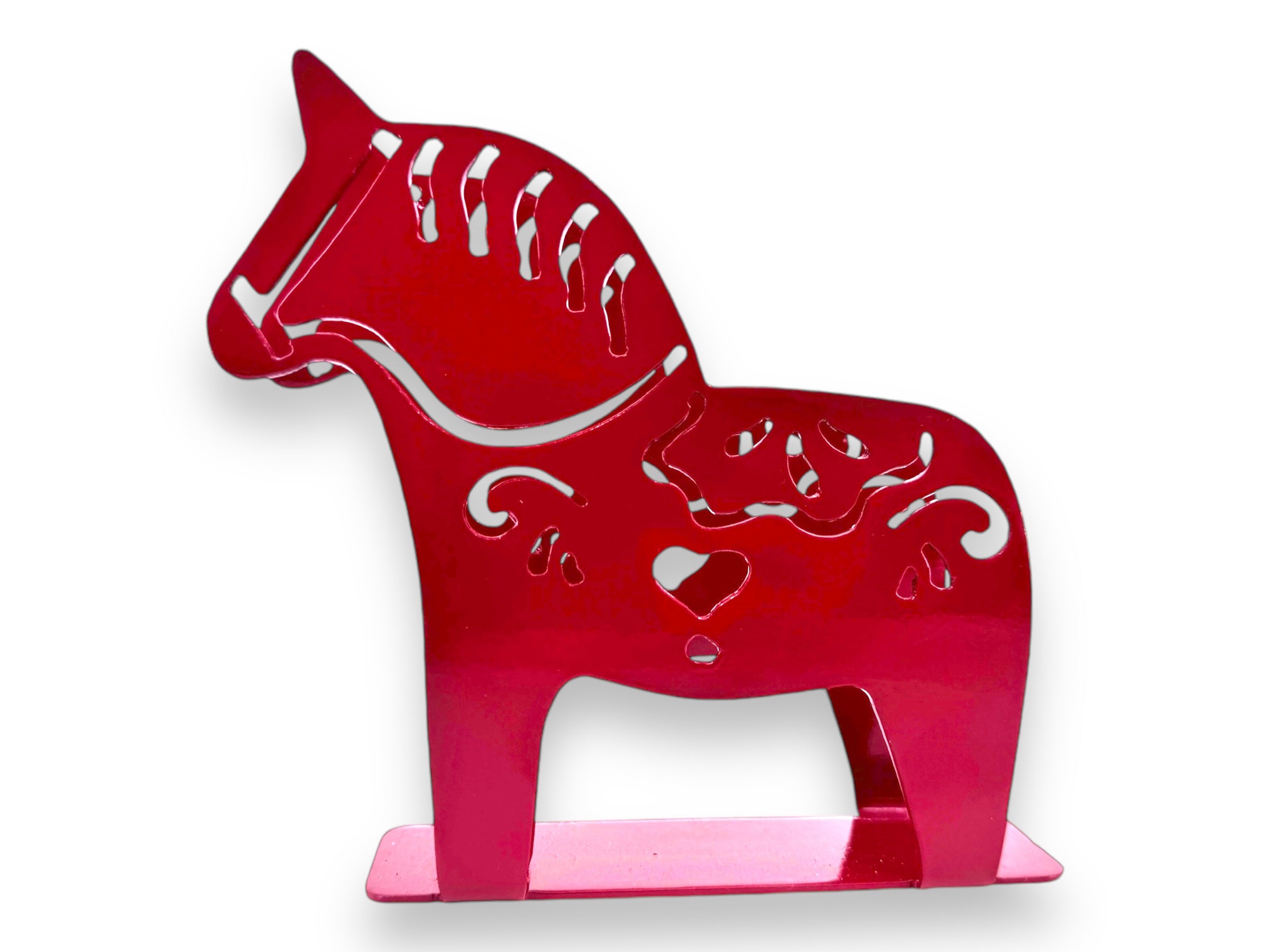 A red metallic Swedish Dala Horse napkin holder with kurbits-inspired cutout patterns stands on a rectangular base, perfect for holding napkins or letters.