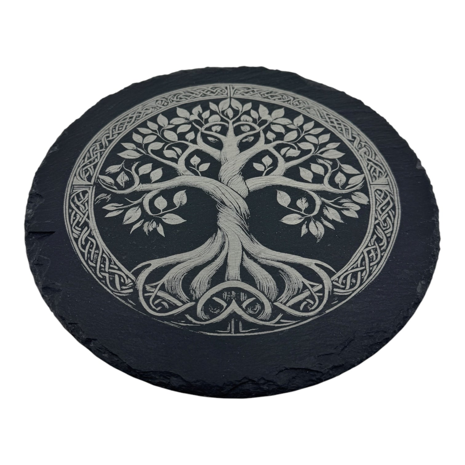 The Trivet: Tree of Life on 9.75 Slate Trivet features a round black slate engraved with an intricate Tree of Life design and a decorative Celtic knot border inspired by Norse mythology.