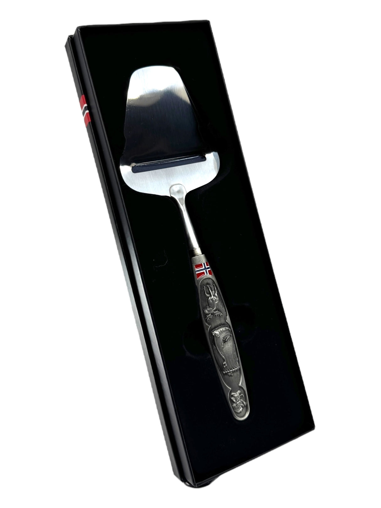 A Norwegian cheese slicer with a pewter handle featuring images of a Viking ship and moose, presented in a black gift box—perfect for celebrating Nordic heritage.