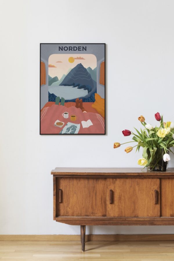 A framed "Morning Coffee - Come to Norden" poster (50 x 70 cm) hangs on a wall above a wooden cabinet with a vase of tulips.