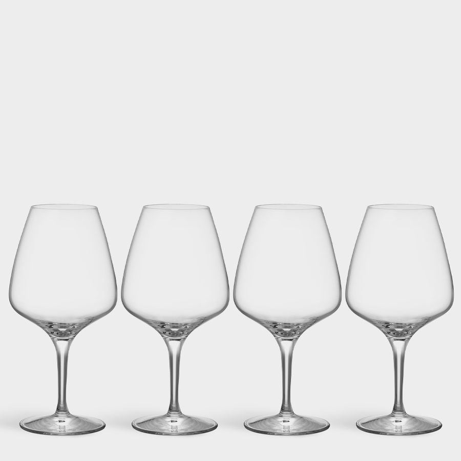 A set of four Orrefors Pulse Wine Glasses, each 15.5oz with a Scandinavian design, stand elegantly on a plain white background.