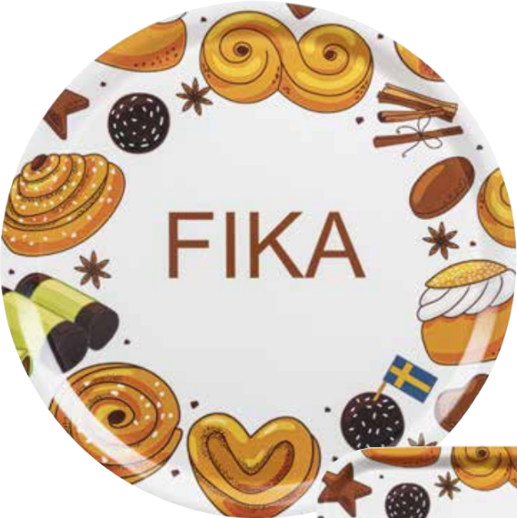 The Round Fika Tray, 38cm, showcases FIKA at its center with charming illustrations of Swedish pastries, a flag, and spices like cinnamon and star anise. Its handcrafted wood design adds Scandinavian charm, making it a perfect centerpiece for cozy gatherings.