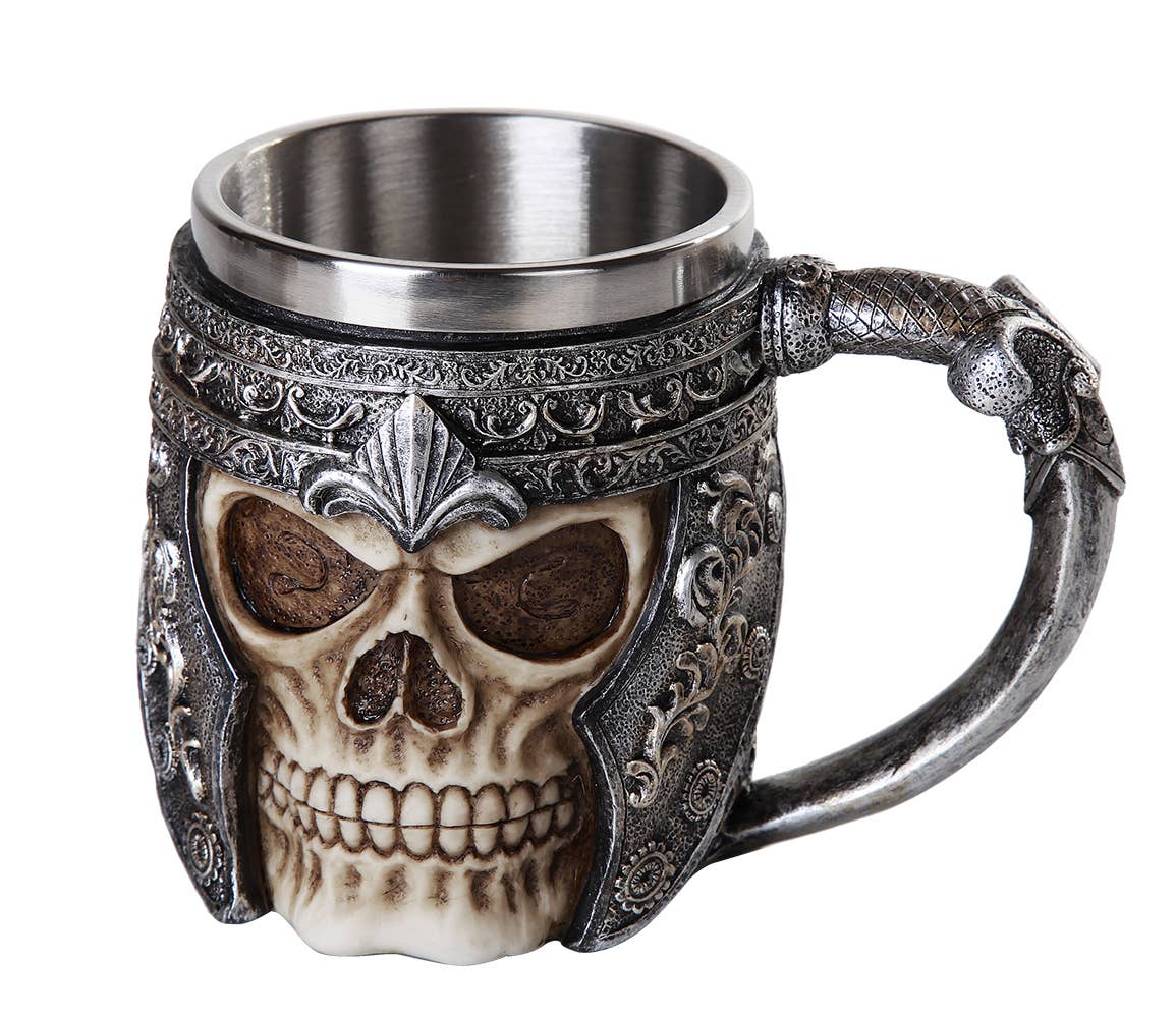 The Mug: Viking Warrior Skull Mug is a metal and resin mug styled as a skull in an ornate helmet, with a sword-shaped handle.