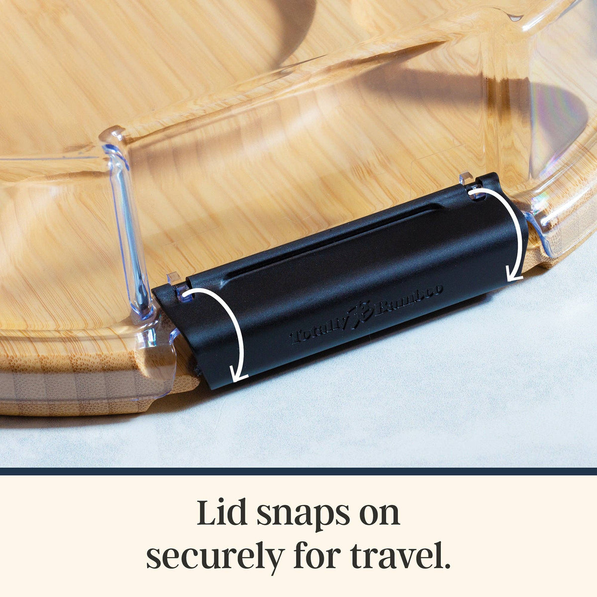 Bamboo charcuterie board with a clear plastic lid and a black locking latch.
