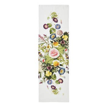 Explore the Runner: Flower Garden Table Runner by Jim Lyngvild Koustrup & Co, featuring a rectangular design with a symmetrical pattern of vibrant flowers and lush green leaves on pure white. Crafted from stone-washed linen, this eco-friendly piece adds an elegant touch of nature to any table setting.