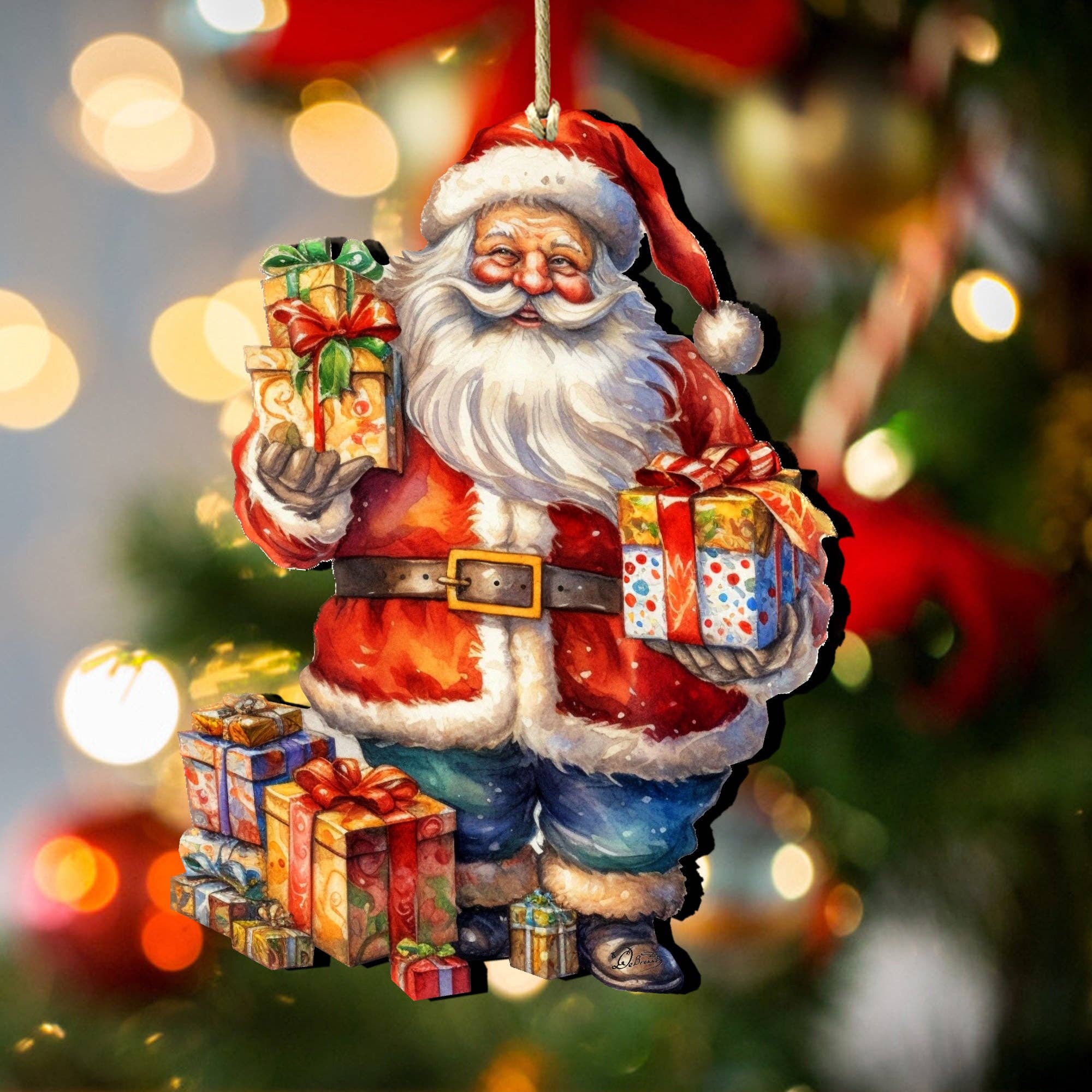 The Merry Delivery Santa Wood Christmas Tree Ornament by Artist g Debrekht, featuring Santa holding gifts, hangs on a decorated tree with blurred lights in the background.