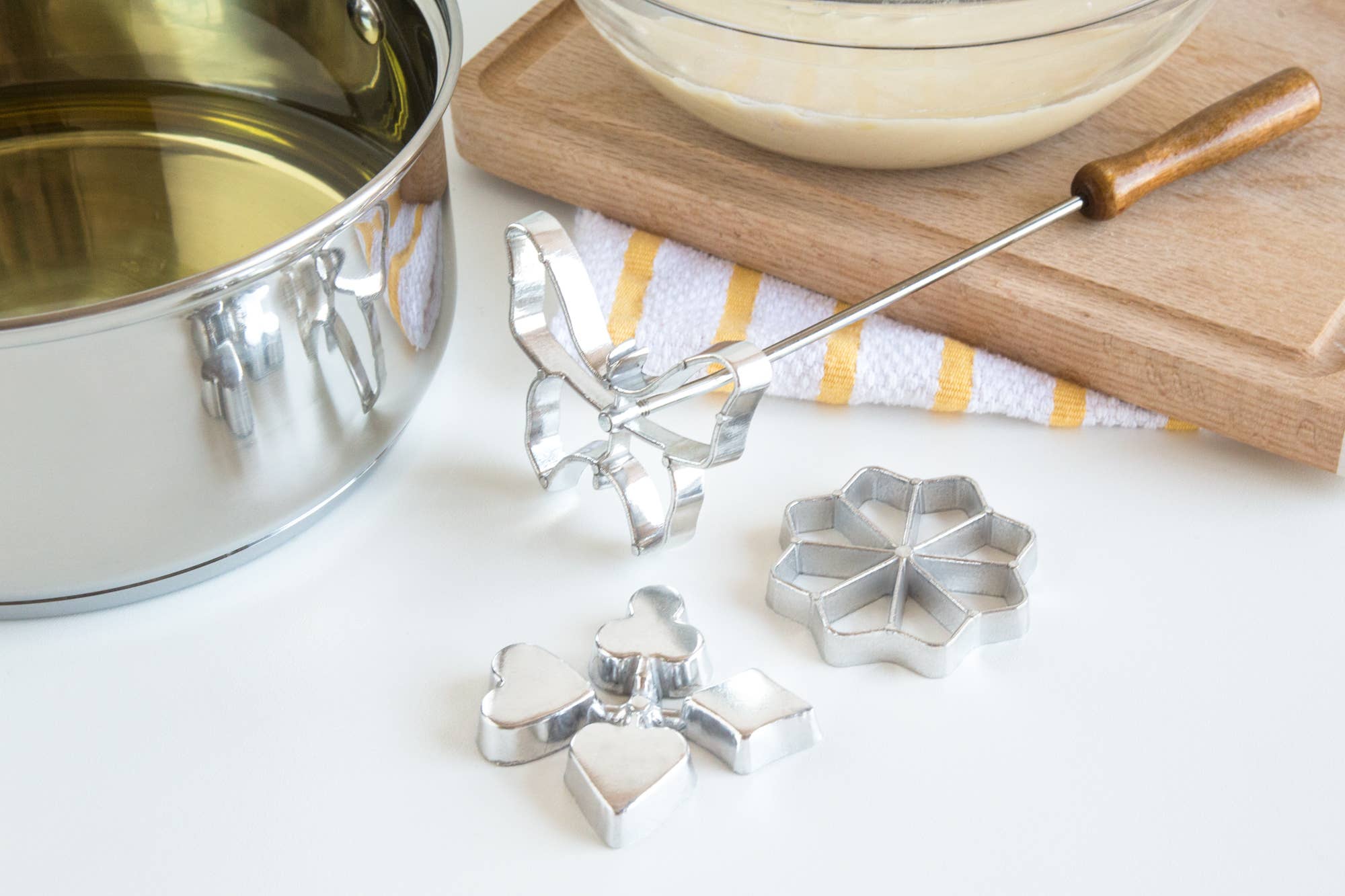 The Cookie Cutter: Rosette Set, Cast-Aluminum, 4-Piece Set includes a cast aluminum rosette iron with wooden handle and three metal molds—everything you need on your countertop to create delicious Scandinavian treats.