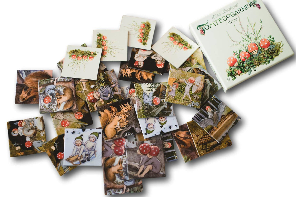 Square illustrated cards lie beside an open box labeled "Game: Elsa Beskow Children of the Forest Memory Game," featuring whimsical fairy-tale images inspired by Elsa Beskow’s classic story.