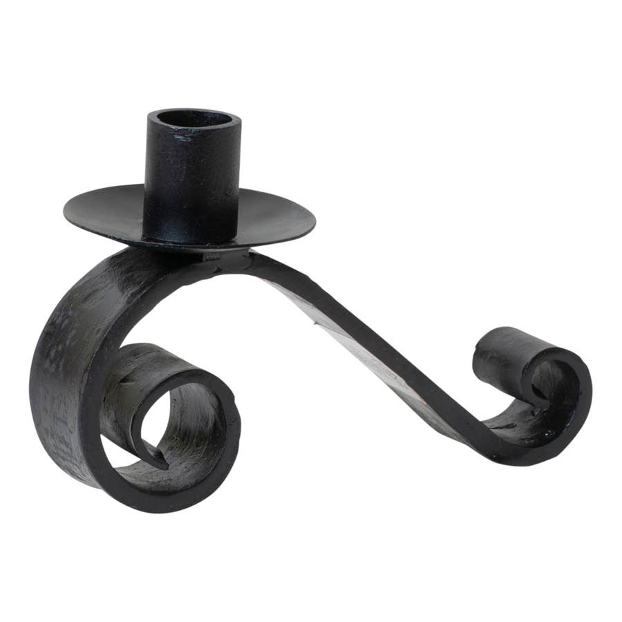 The Candle Holder: Wrought Iron Curled Pillar Candle Holder features blacksmith-crafted wrought iron, a single pillar holder, and two decorative curled ends, shown against a white background.