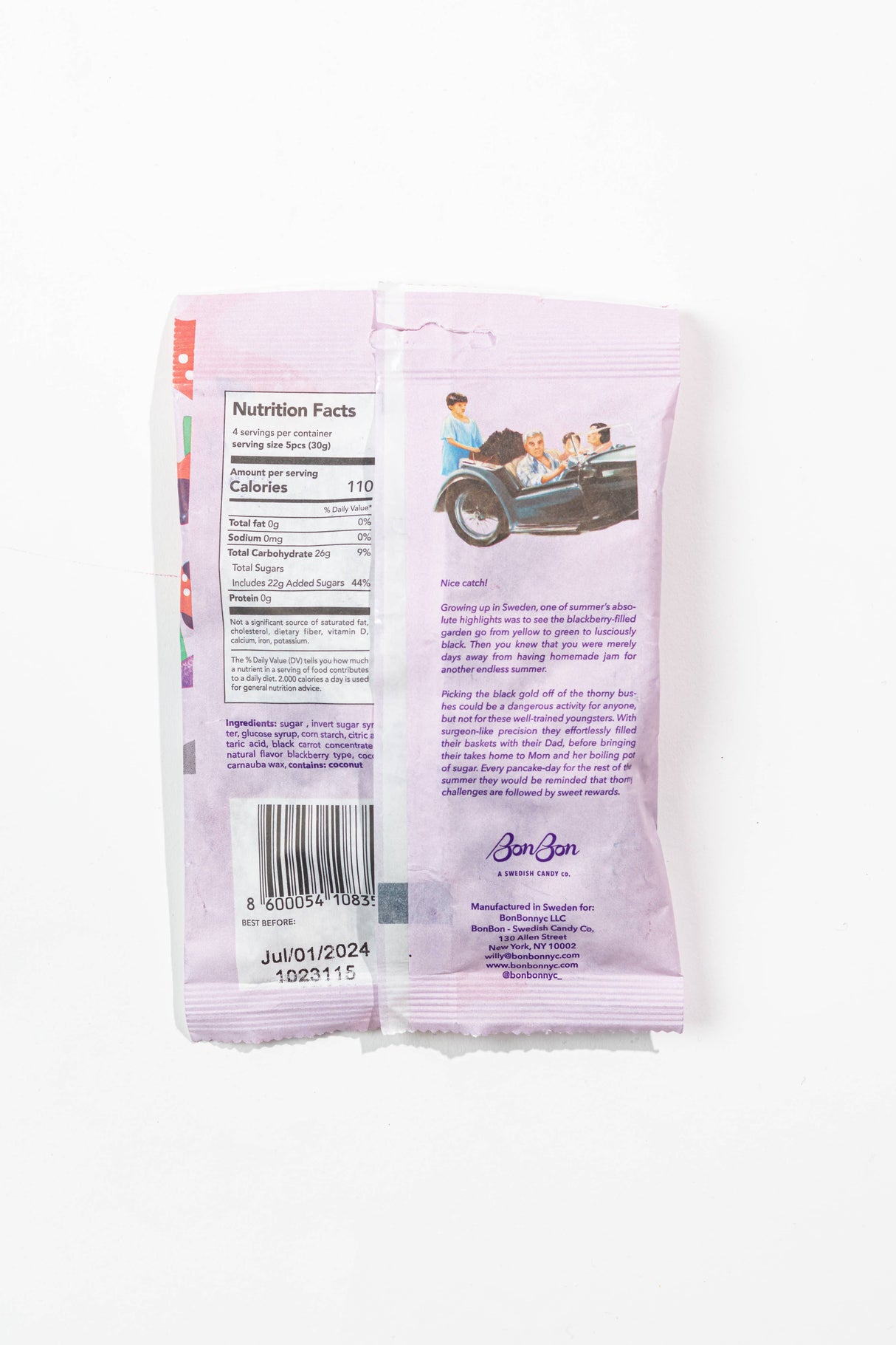 A lavender wrapper features a barcode, nutrition facts, vintage car art, and product info on the back, suggesting it contains Candy: Bon Bon - Sour Blackberry Fish (150g) 5.2oz vegan gummies inside.