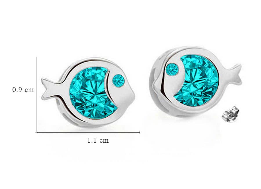 A pair of fish-shaped silver studs featuring princess-cut aquamarine Swarovski® crystals, each measuring 0.9 x 1.1 cm. One earring is shown next to a size reference. Product: Earrings: Fish Shaped Swarovski® Crystal Silver Studs.