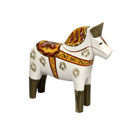 A hand-carved antique-inspired Swedish Dala Horse features decorative patterns on a white base with either green or blue feet and ears, standing elegantly on a light gray background.