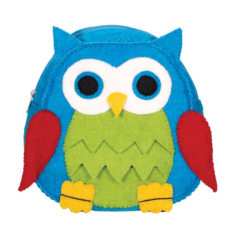 Introducing the Bag: Felted Wool Owl Backpack, a vibrant, handcrafted accessory designed as an owl. Featuring colorful blue, green, and red felt fabric accented by large white eyes and adorned with a bright yellow beak and feet.