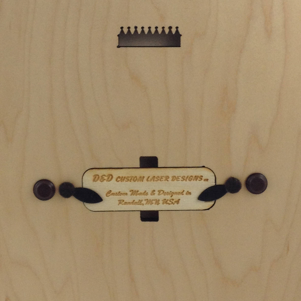 The Cribbage: Minnesota Phrases Cribbage Board features a premium maple wood surface, a crown-shaped cutout, and a plaque engraved with D&D Custom Laser Designs – Custom Made in Randall, MN. Ideal for fans of fine Minnesota phrases and craftsmanship.