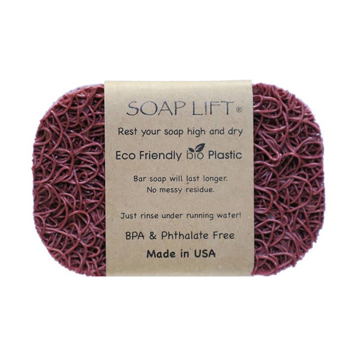 The Original Soap Lift Soap Saver by Faire – Soap Lift is a maroon, oval, mesh-textured eco-friendly soap holder with a brown paper label. Made in the USA from BPA- and phthalate-free bio plastic, it keeps your bar high and dry. Multiple colors available.