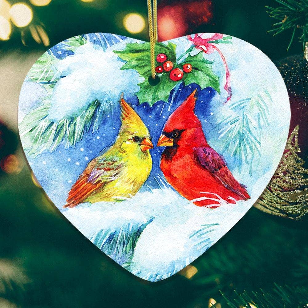 The Watercolor Cardinal Mistletoe Romance Christmas Heart Shaped Ornament adds charm to holiday decor with its watercolor depiction of a cardinal on snow-covered branches.