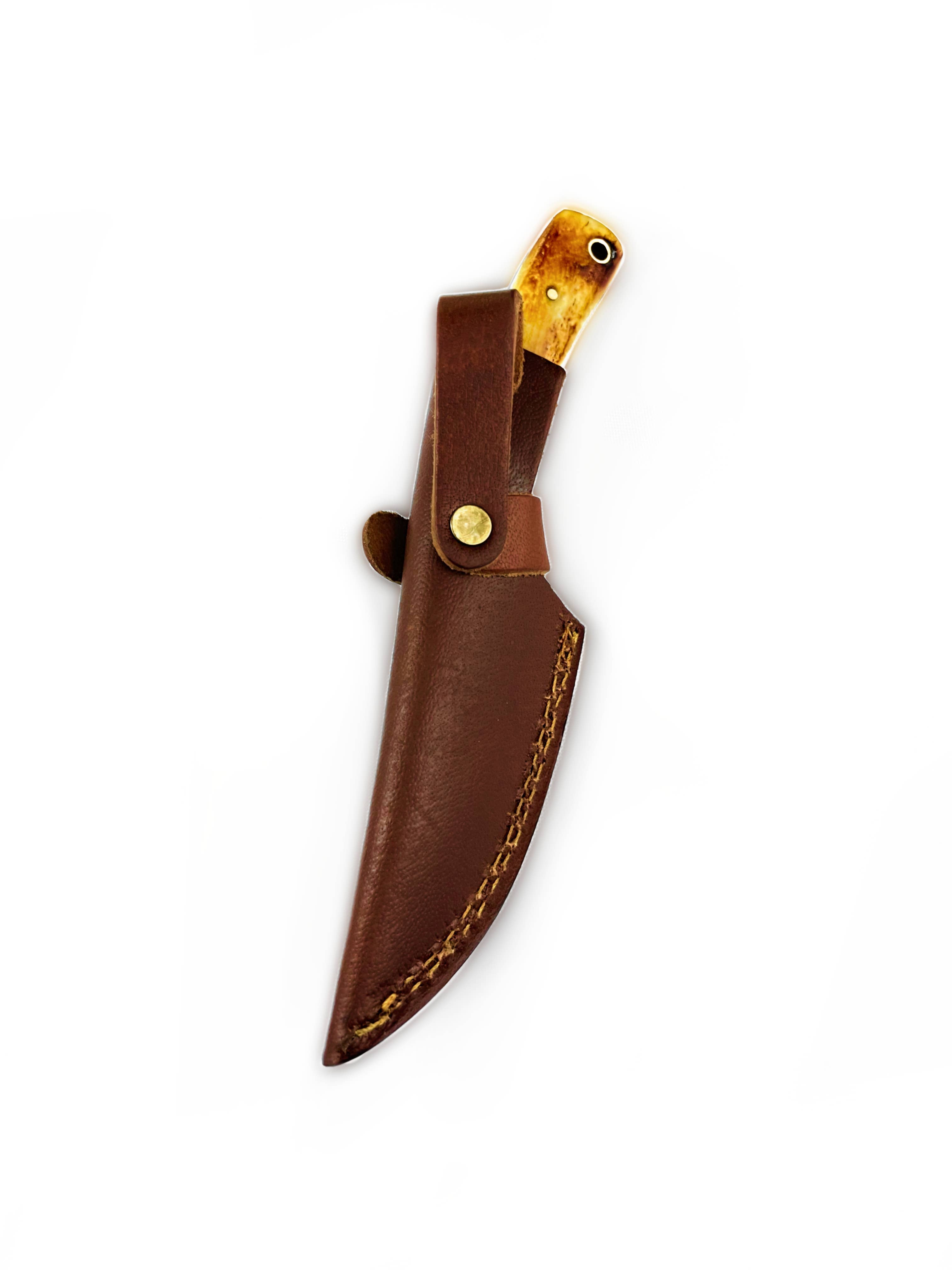 The Knife: Carbon Skinning/Hunting Knife features a durable 1080 high carbon steel fixed blade and wooden handle, partially visible in its brown leather sheath with buttoned strap, set against a white background.