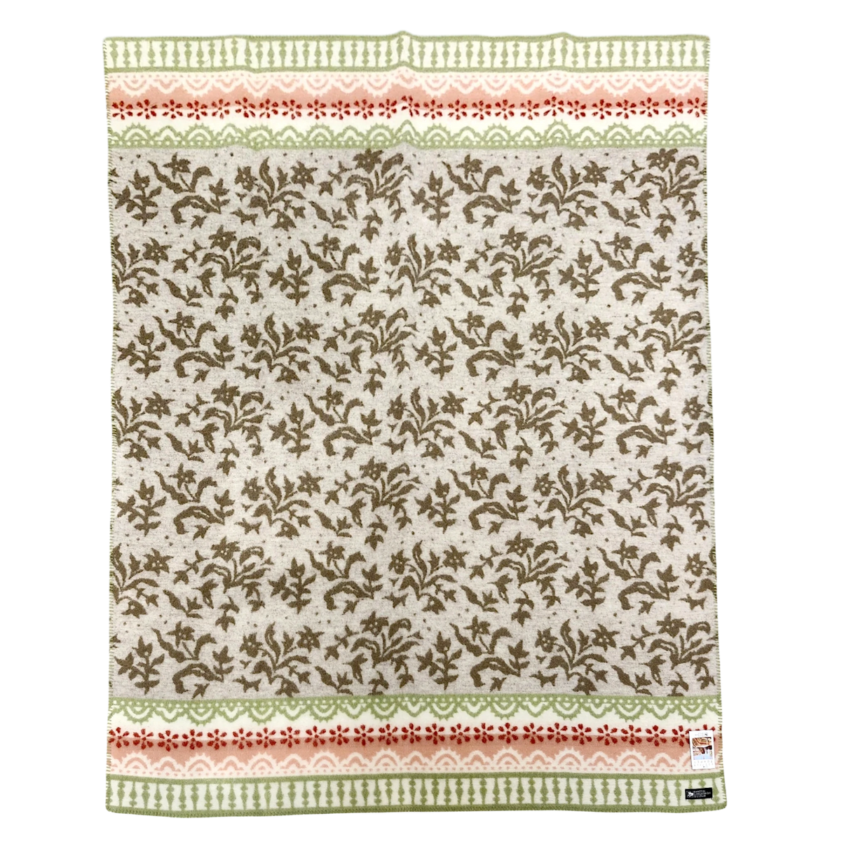 Beige lambswool blanket featuring green and pink borders, a brown leafy pattern in the center, and a small label sewn onto the bottom right corner.