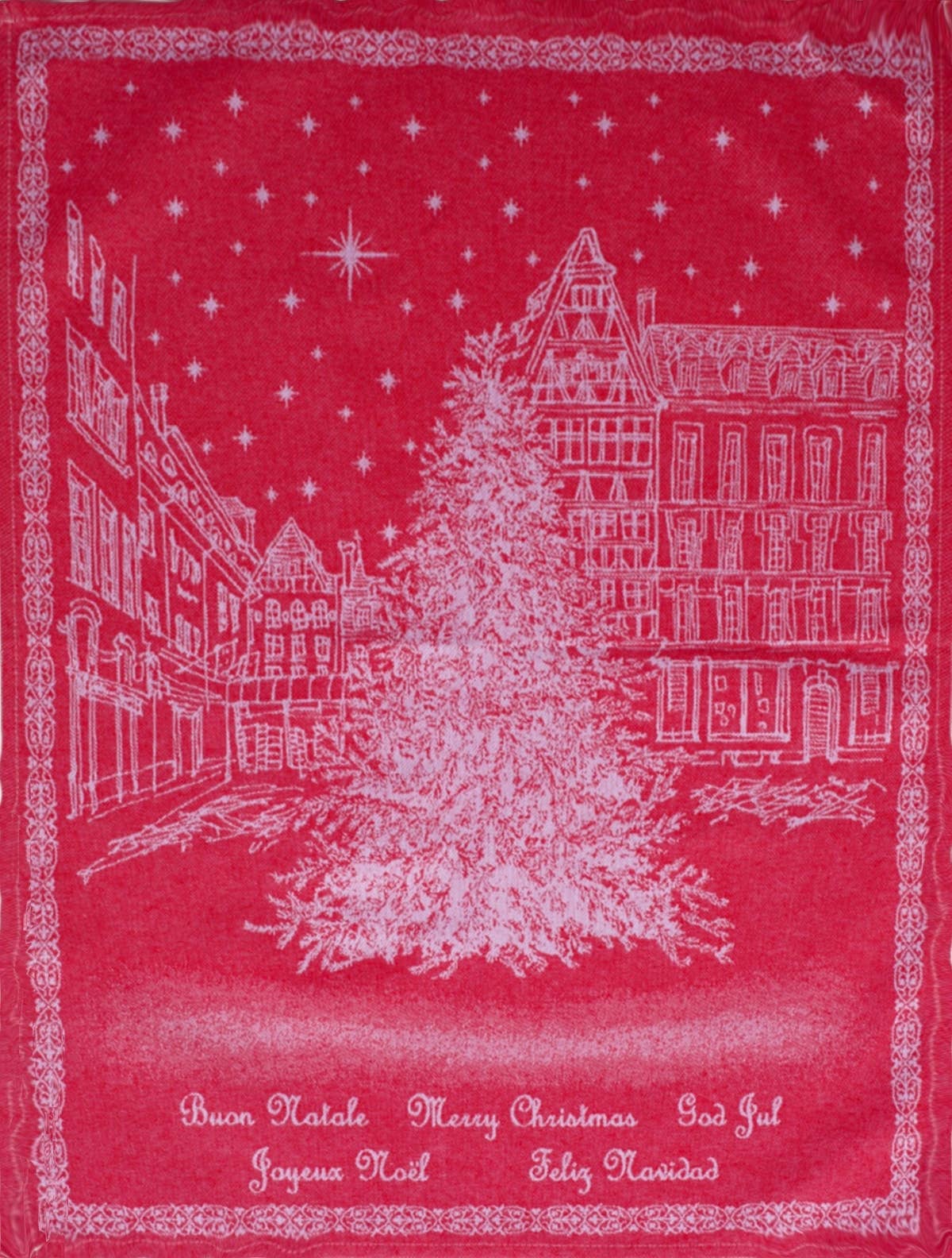 The Holiday European Village Woven Jacquard Tea Towel (20 x 28) features a white illustration of a decorated Christmas tree in a town square with “Merry Christmas” in various languages—perfect for festive kitchen décor.