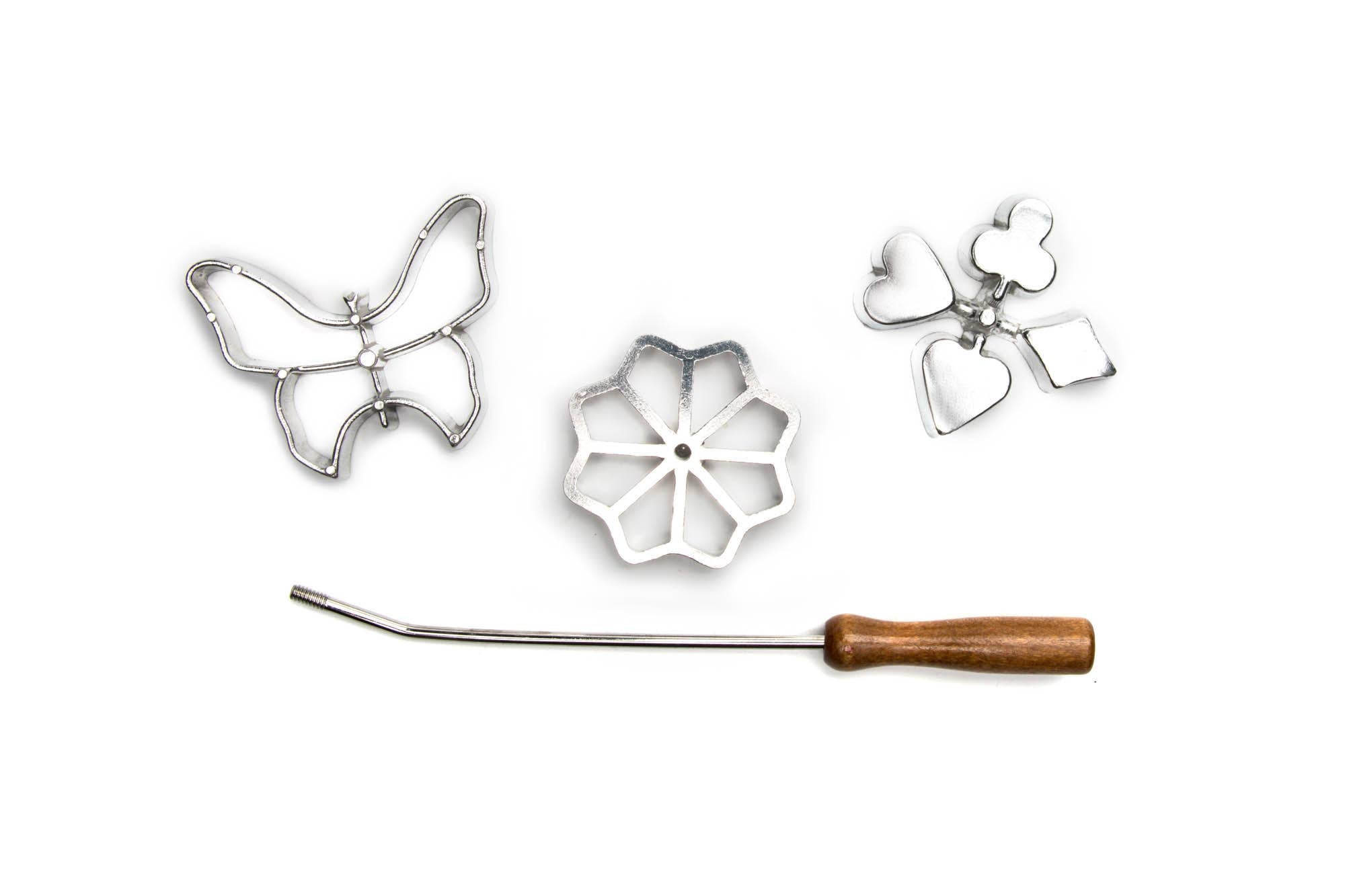 The Cookie Cutter: Rosette Set is a 4-piece cast-aluminum set featuring butterfly, flower, and cluster shapes plus a wooden-handled rod—ideal for making traditional Scandinavian rosette cookies.