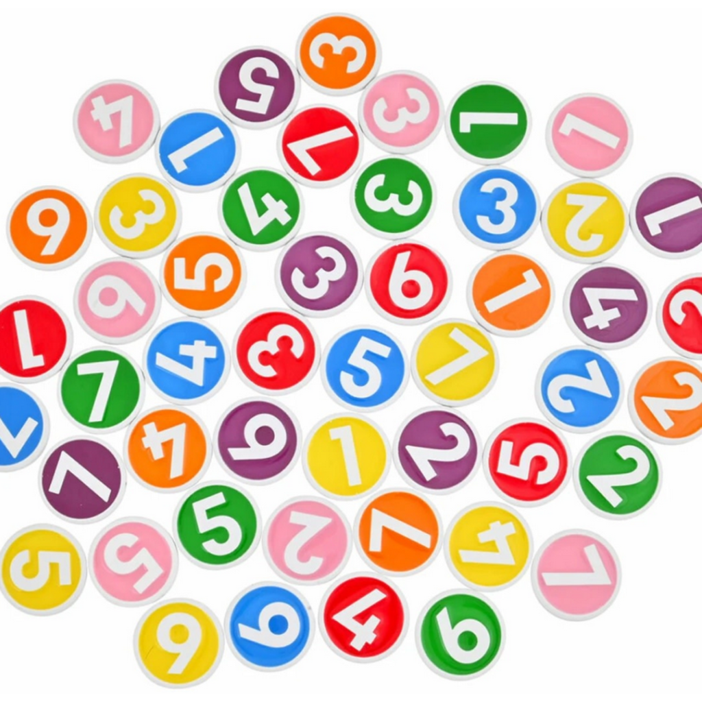 Bright plastic chips from Game: Chipzi - Fast Flippin' Fun! by Tenzi - Carma Games LLC feature bold white numbers from 1 to 7 on backgrounds of green, yellow, orange, red, purple, blue, and pink. These colorful pieces—ideal for a lively family game night—are scattered at random across a white surface.