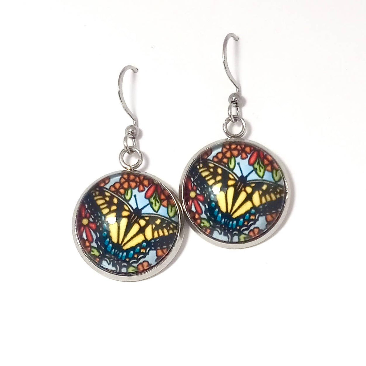 Explore the allure of handmade earrings featuring vivid Swallowtail butterfly designs, set in metal hooks with exquisite glass dome cabochons. Inspired by the creative artistry of Sarah Angst Art, each piece exudes distinct elegance.