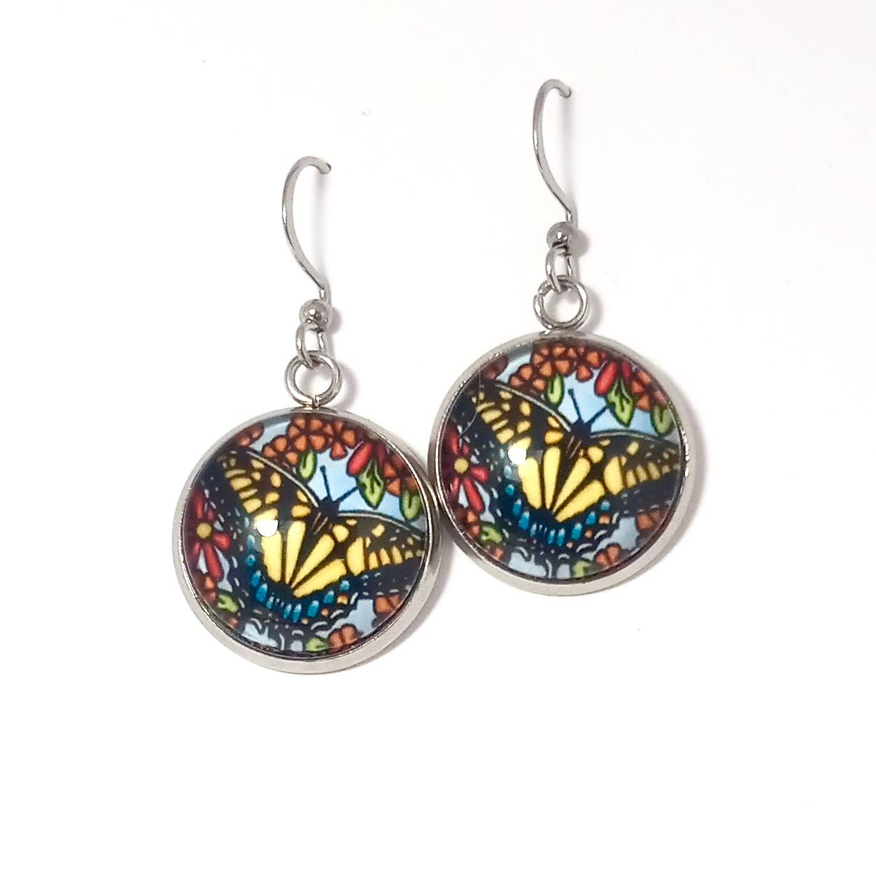 Explore the allure of handmade earrings featuring vivid Swallowtail butterfly designs, set in metal hooks with exquisite glass dome cabochons. Inspired by the creative artistry of Sarah Angst Art, each piece exudes distinct elegance.