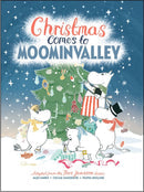 Cover illustration of the book "Christmas Comes to MoominValley" by Tove Jansson, showcasing the Moomins happily adorning a Christmas tree with festive decorations under a starry night sky.