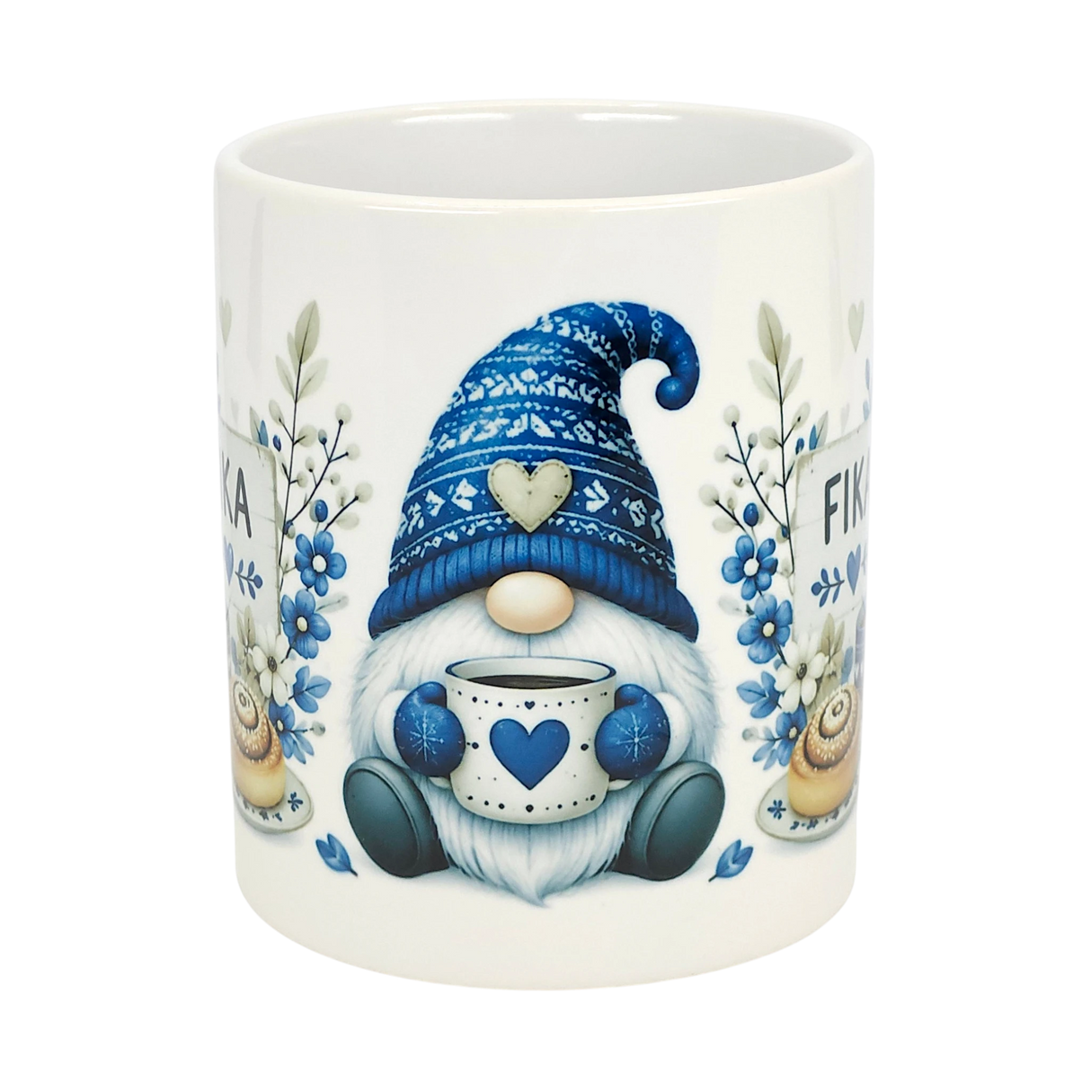 The Nordic Wholesale Mug: Blue Tomte Gnome Fika Ceramic Mug (11 oz) features a Scandinavian gnome with a blue hat, holding a heart mug, surrounded by blue flowers and pastries. "FIKA" appears in the background.